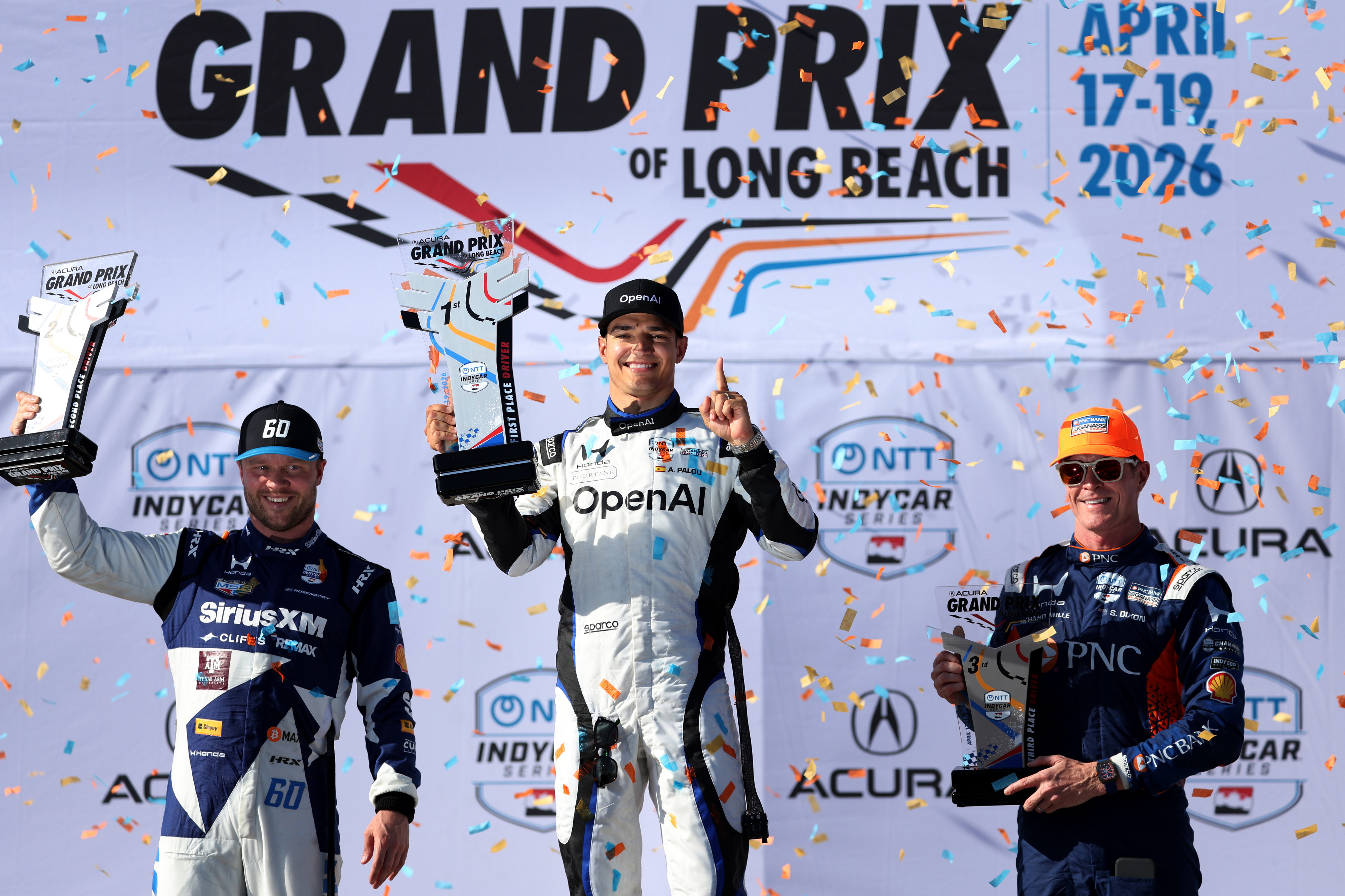 Winning Indycar driver Alex Plaou, center, celebrates alongside second place...