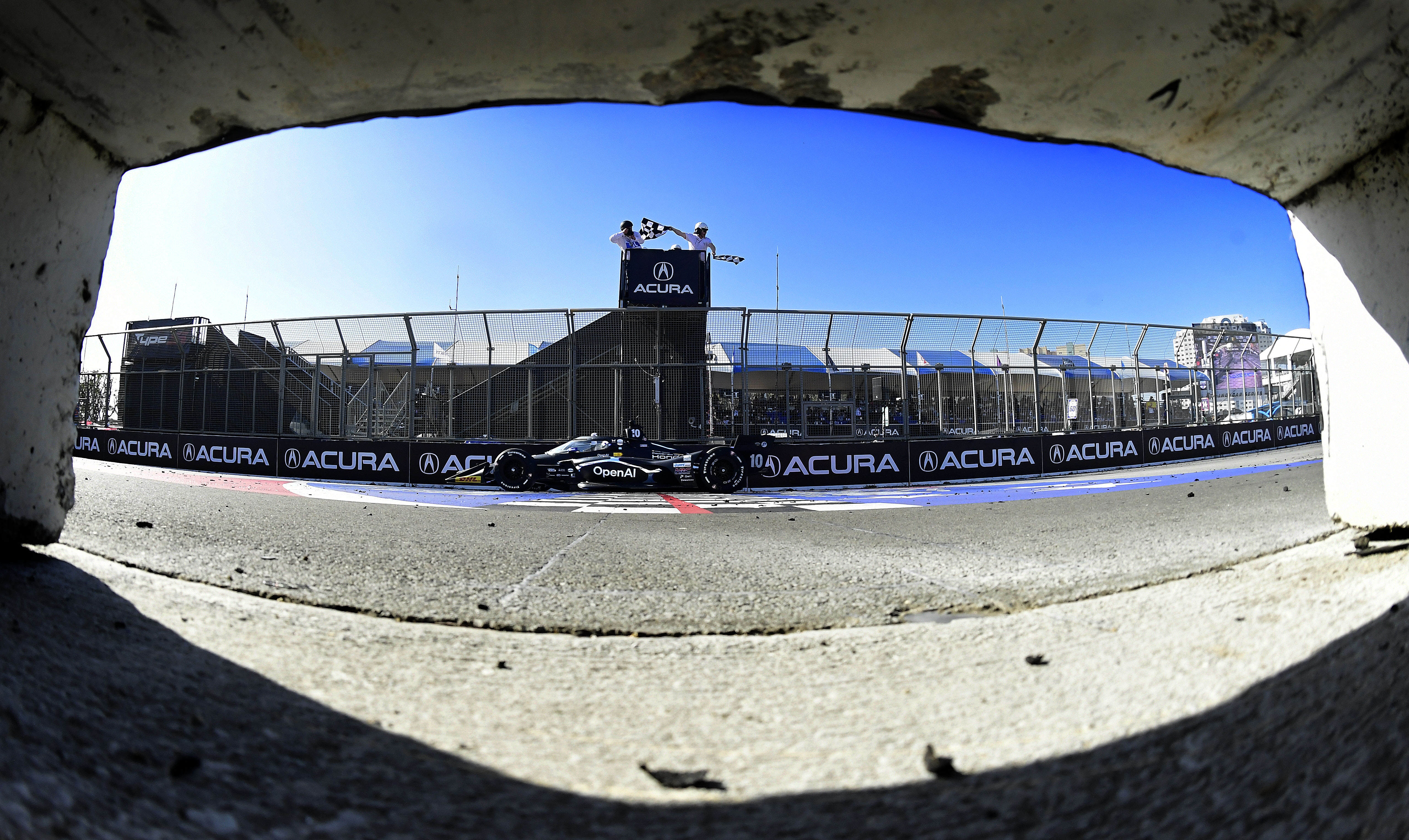 Indycar driver Alex Palou takes the checkered flag to win...