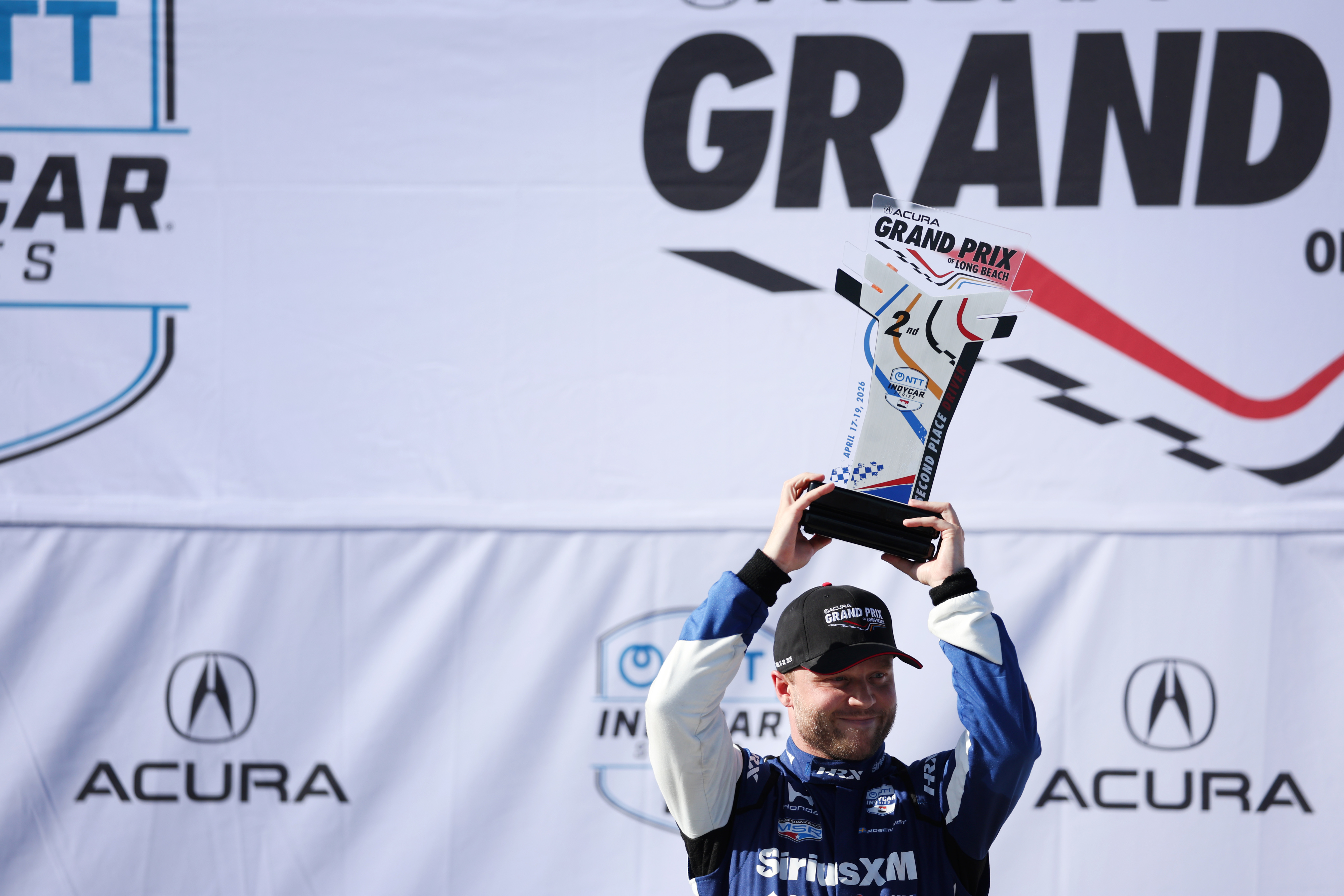 Indycar driver Felix Rosenqvist celebrates after finishing second in the...