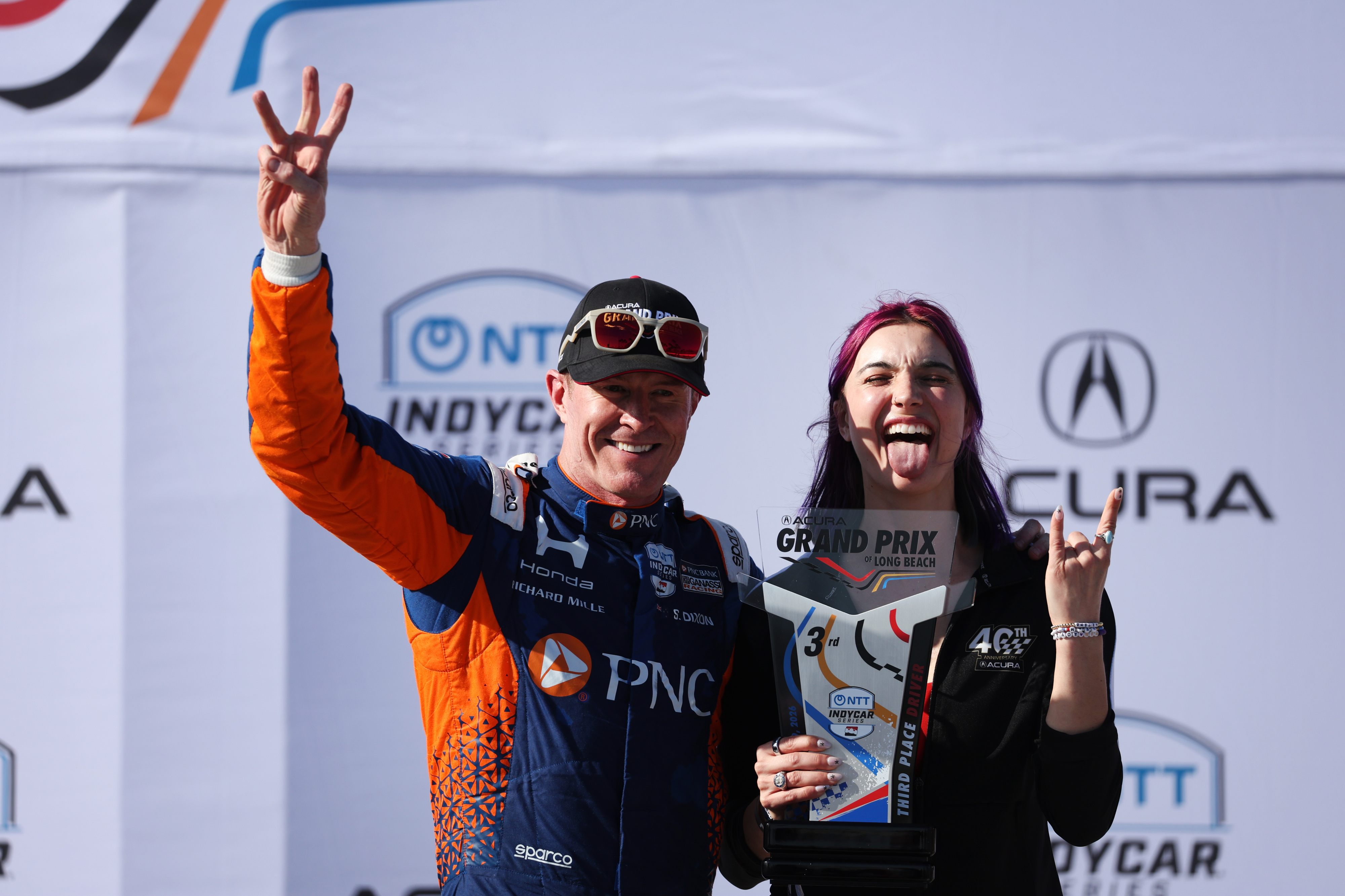 Third place Indycar driver, Scott Dixon, left, celebrates alongside Paralympic...