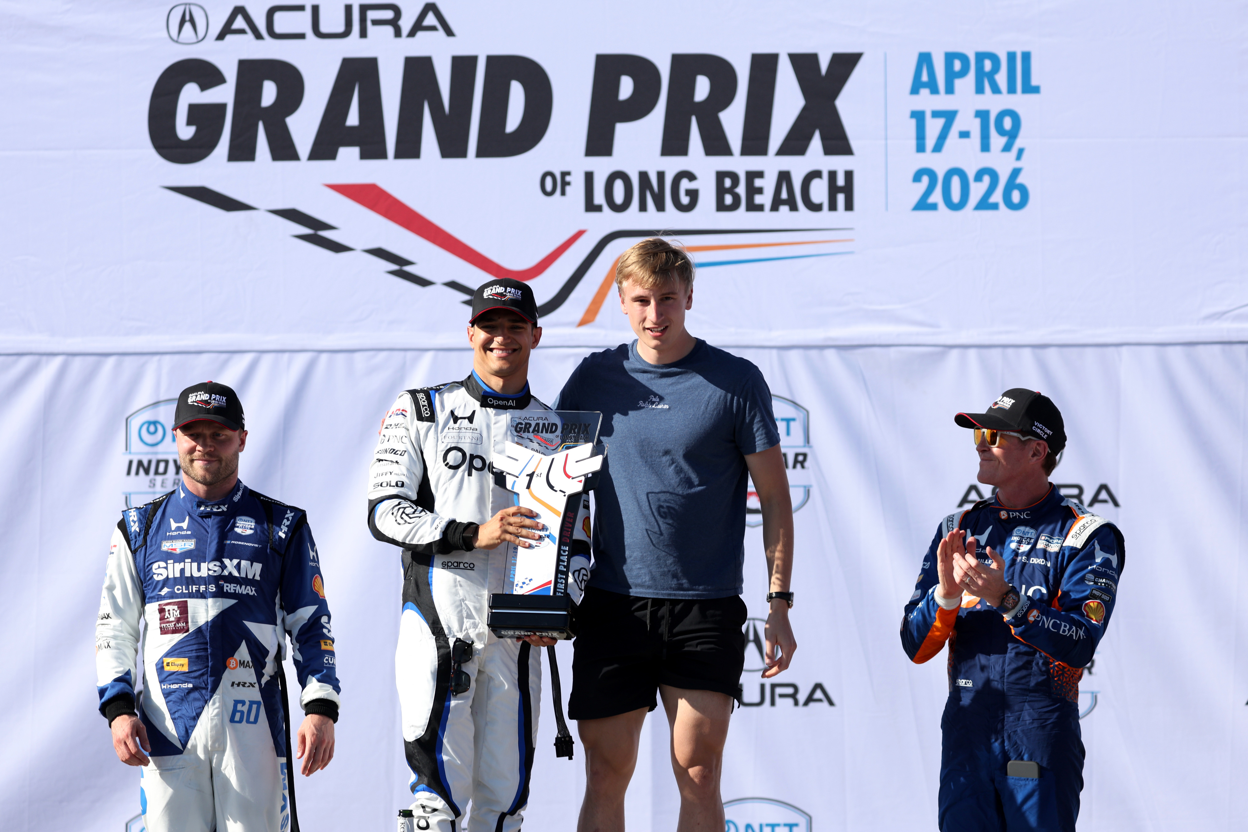 Winning Indycar driver, Alex Palou, center left, poses for a...