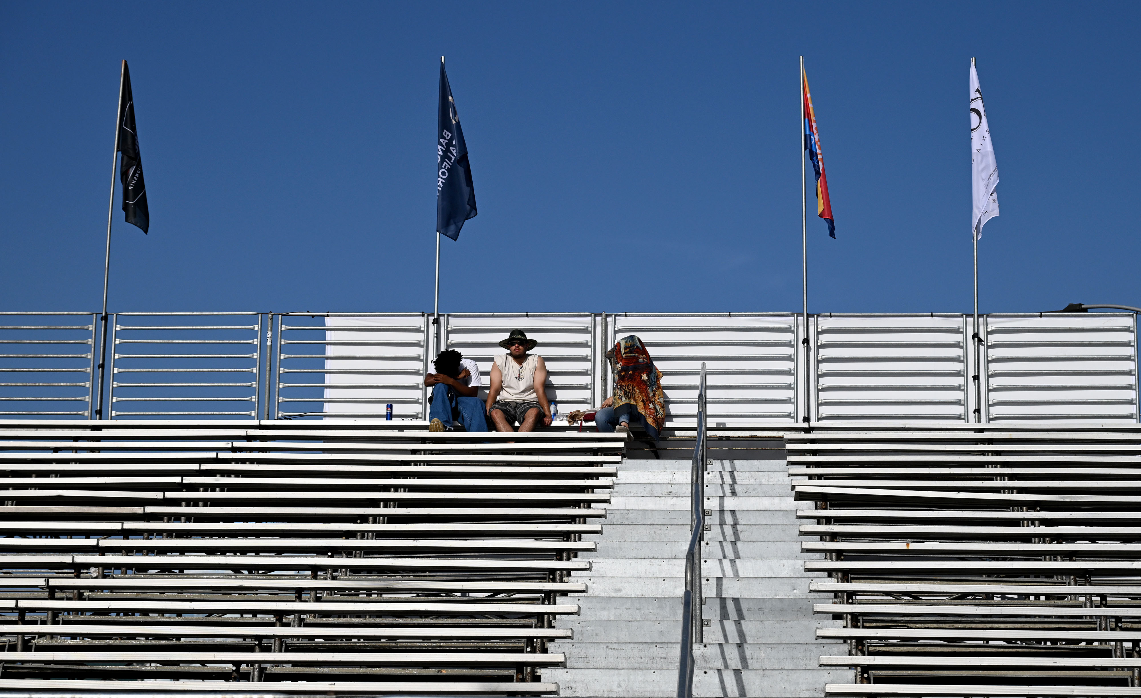 Early bird race fans watch people participating in the VIP...