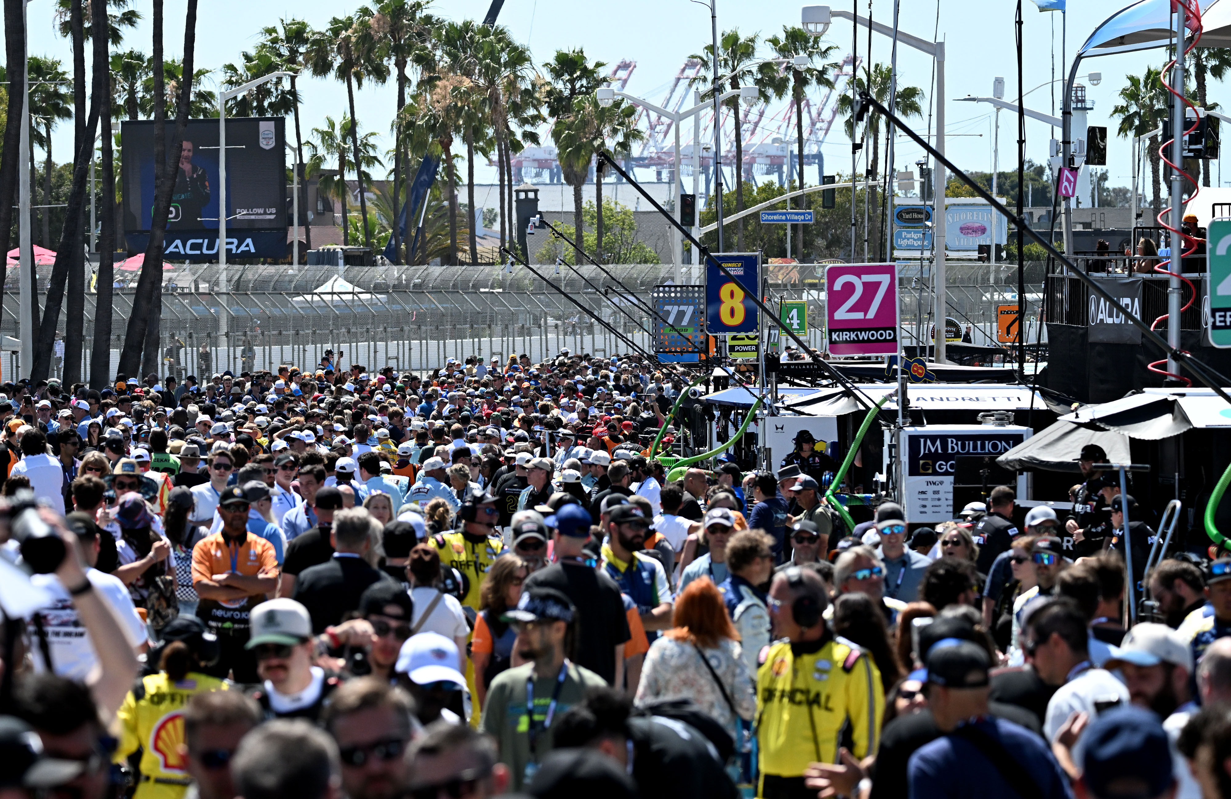 Pit lane is filled with race fans prior to the...