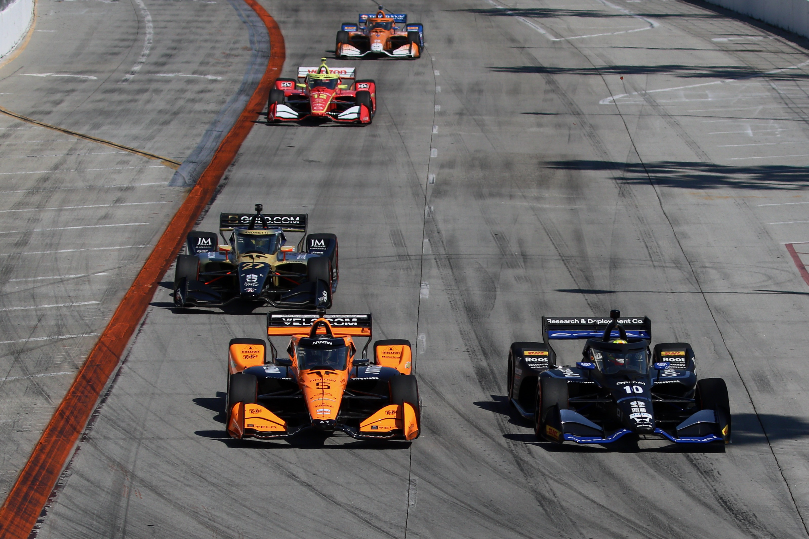 Alex Palou (#10) and Pato OâWard (#5) lead a group...