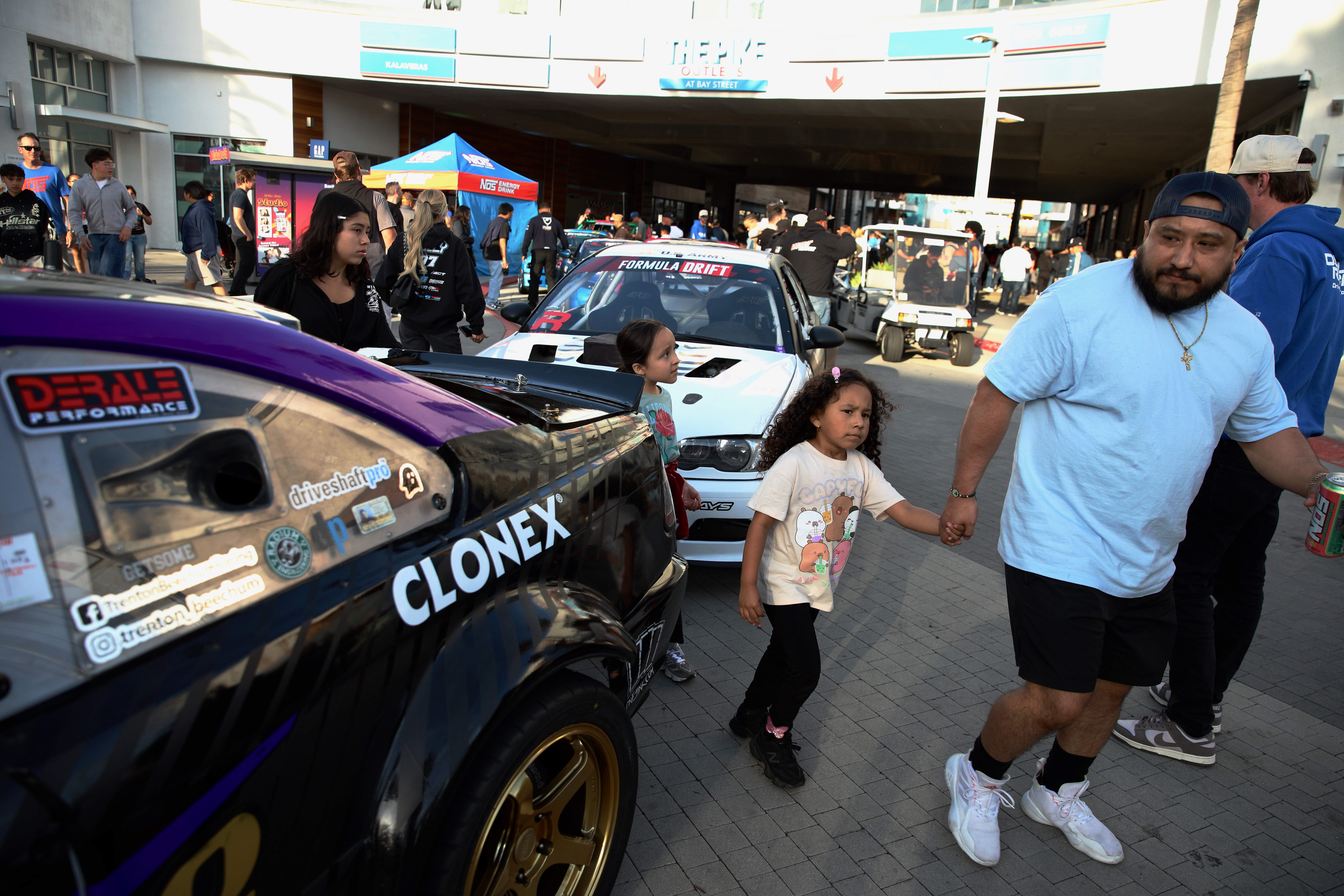 Attendees check out the Formula DRIFT cars on display at...