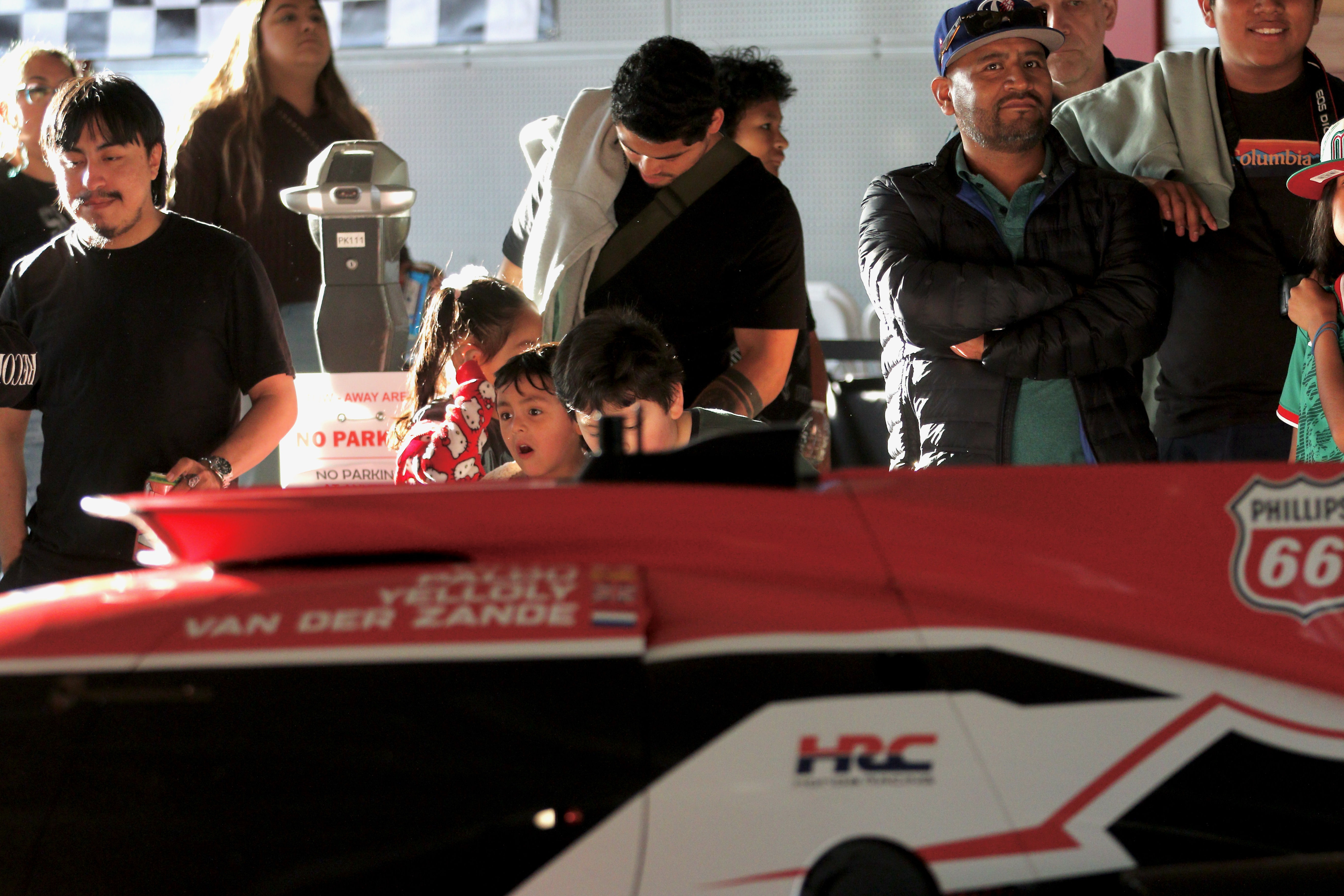 Attendees check out the various racing series cars at Thunder...