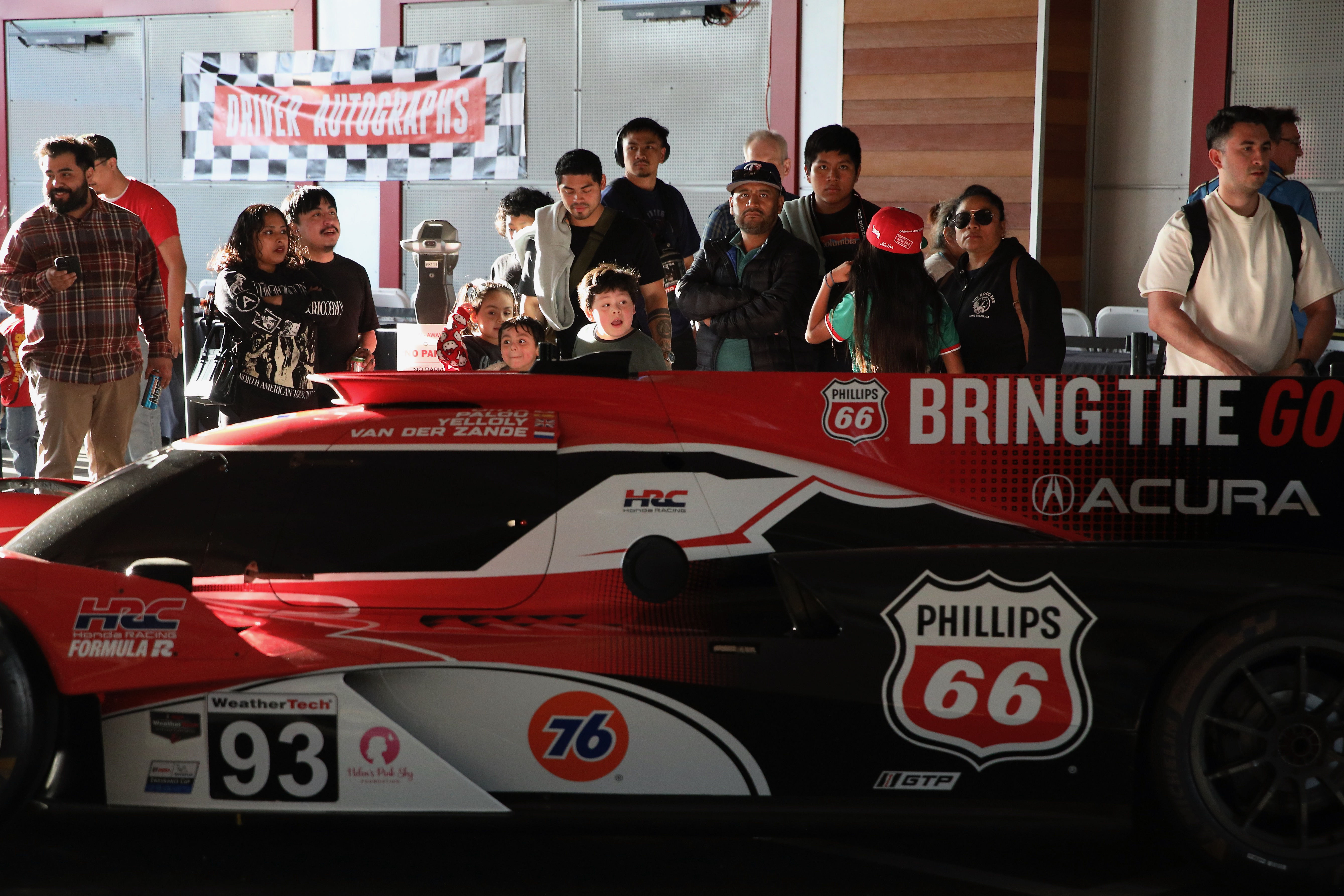 Attendees check out the various racing series cars at Thunder...