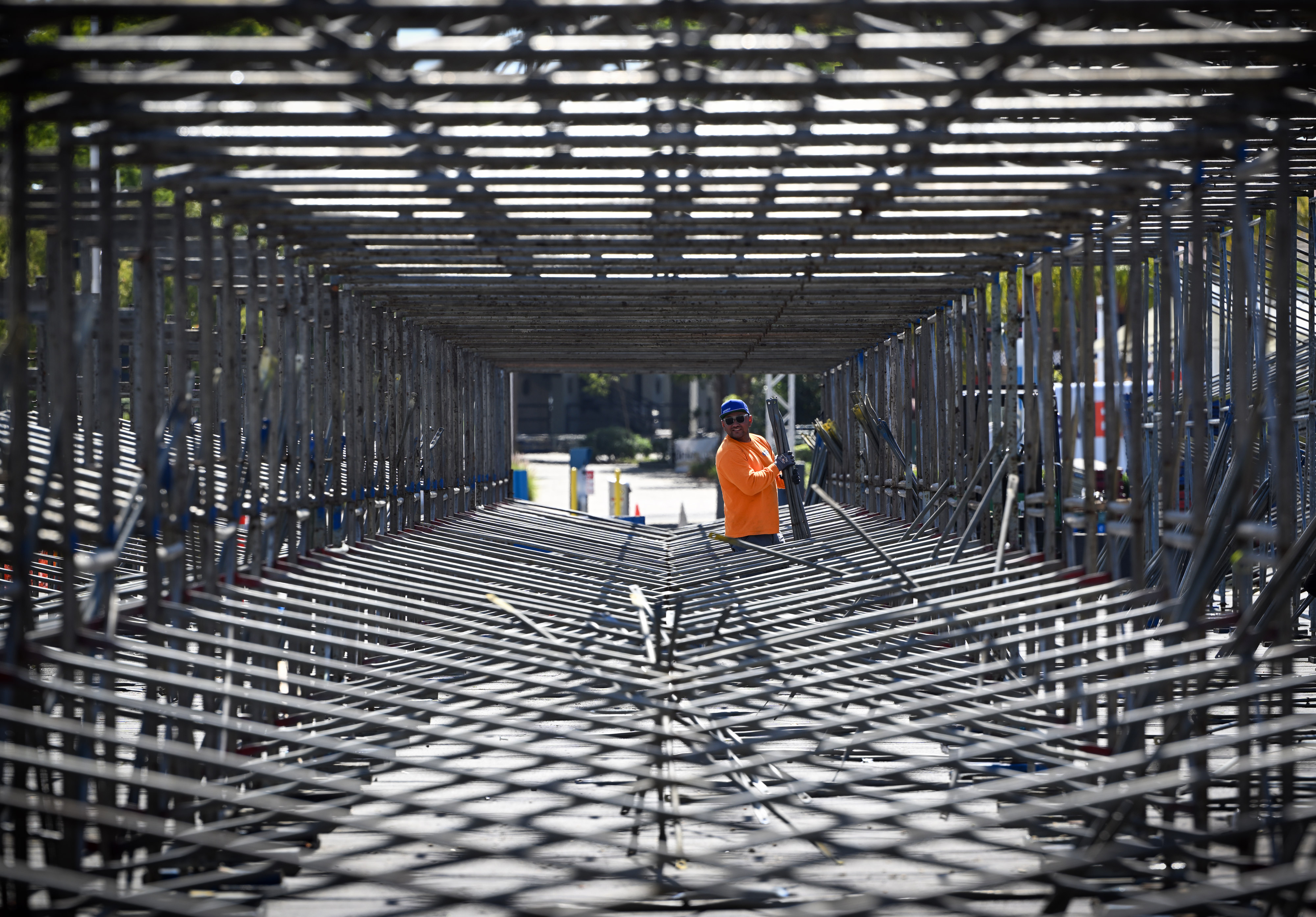 Workers dismantle grandstands in front of businesses along Shoreline Drive...