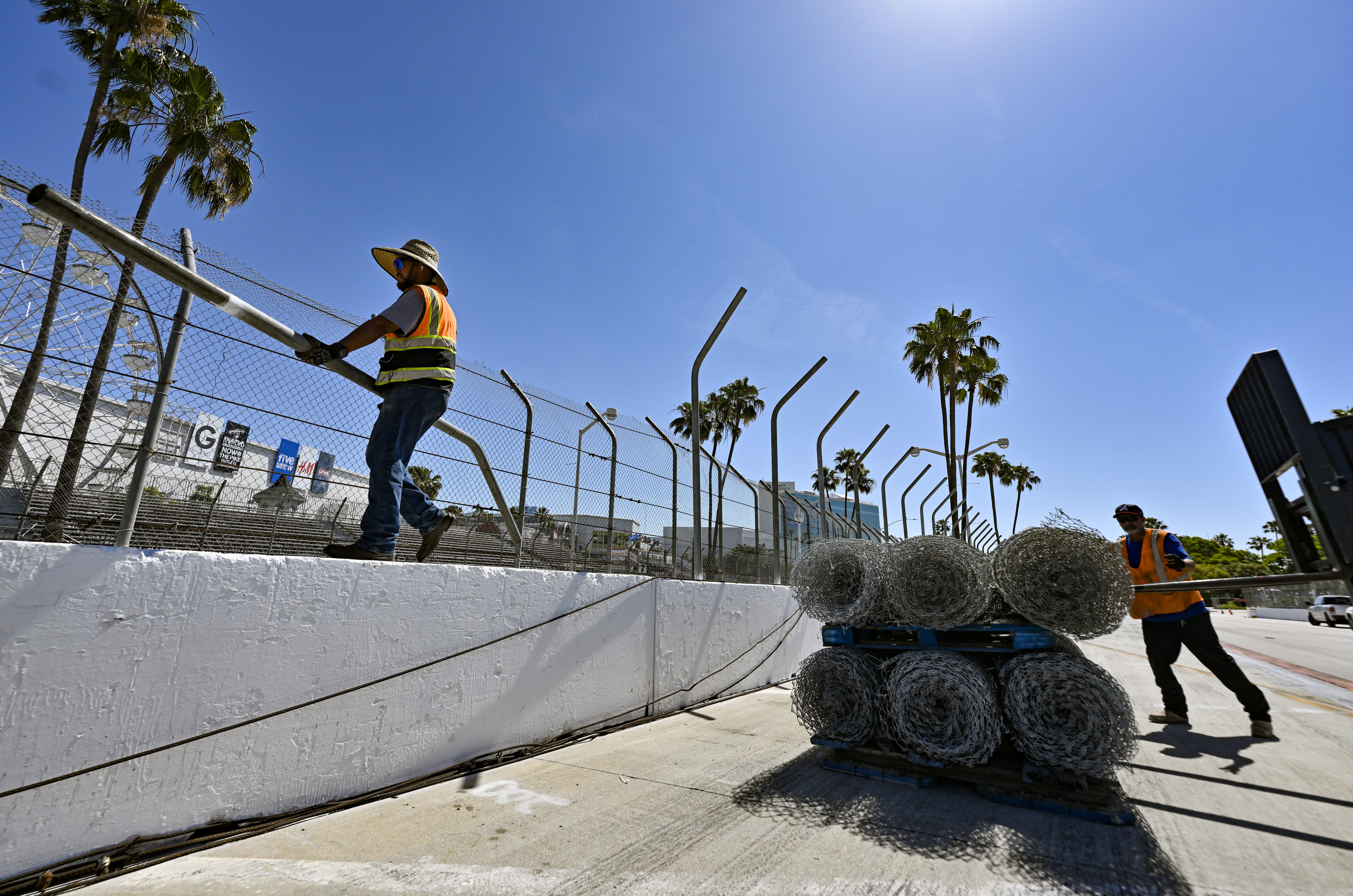 Ronald Robles walks along cement barricades as he dismantles Grand...