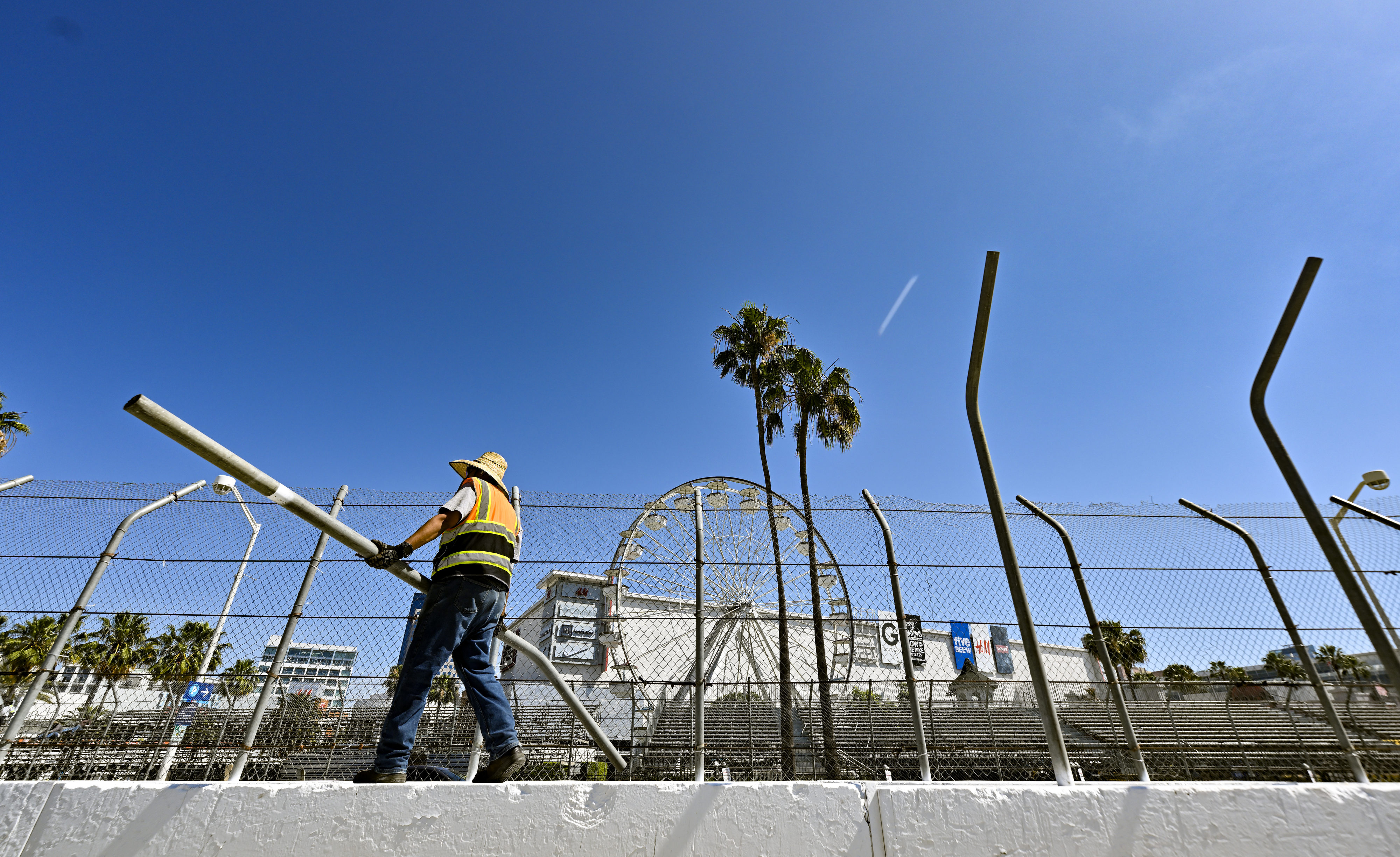 Ronald Robles walks along cement barricades as he dismantles Grand...