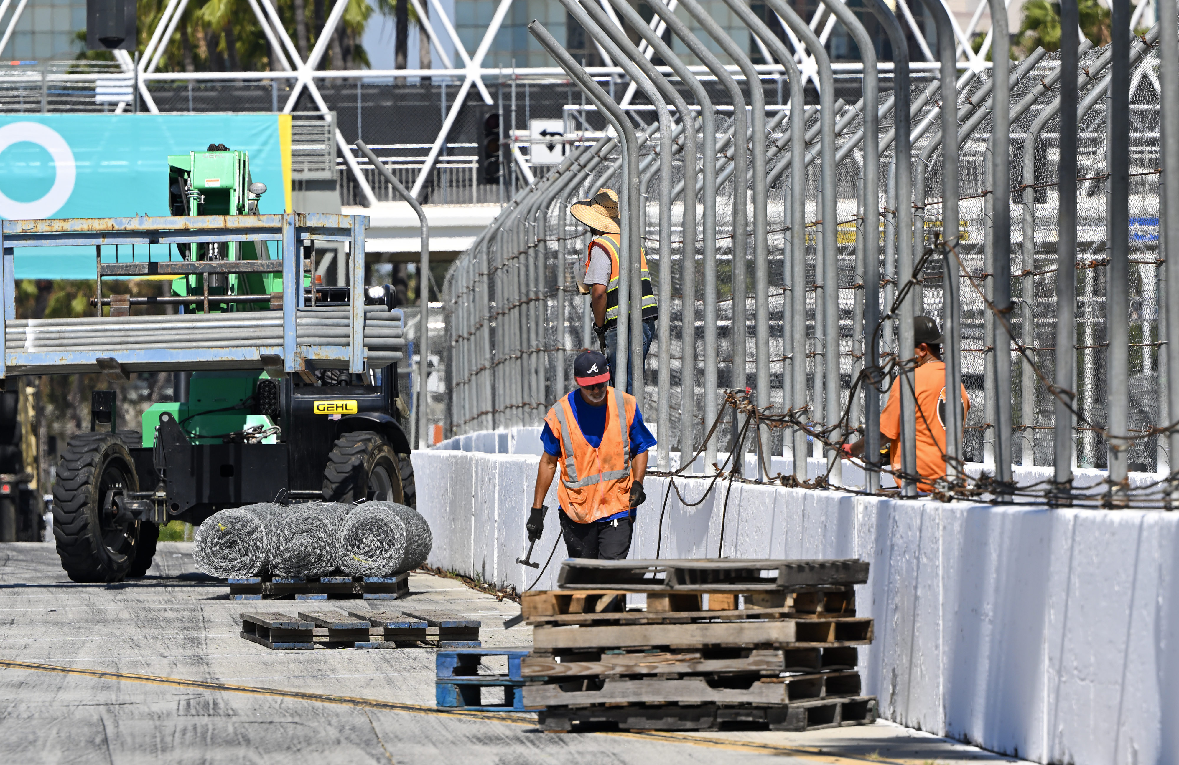 Workers dismantle Grand Prix fencing along Shoreline Drive in Long...