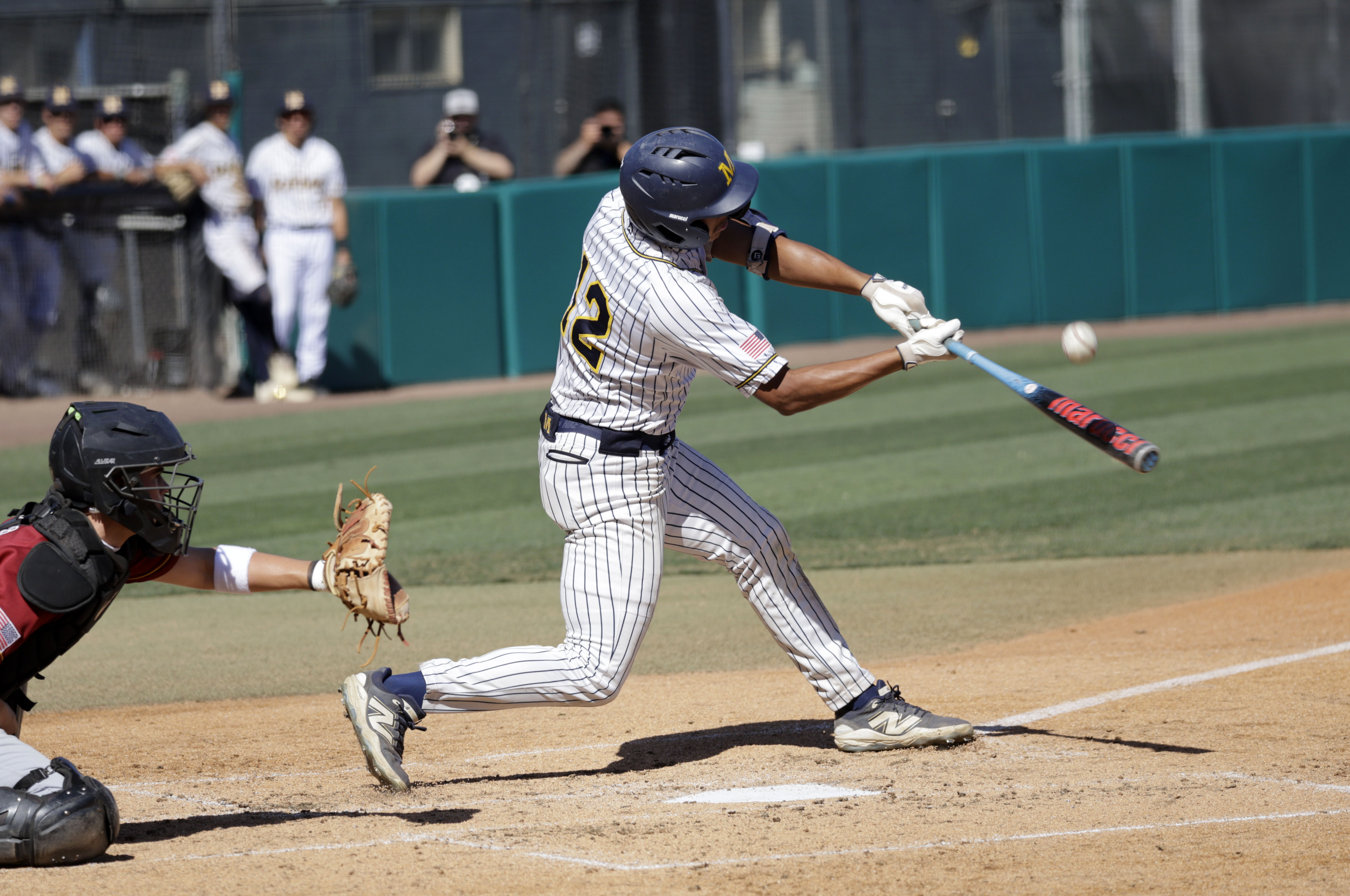 Millikan’s Ethan Briones (12) gets a hit as the Rams...
