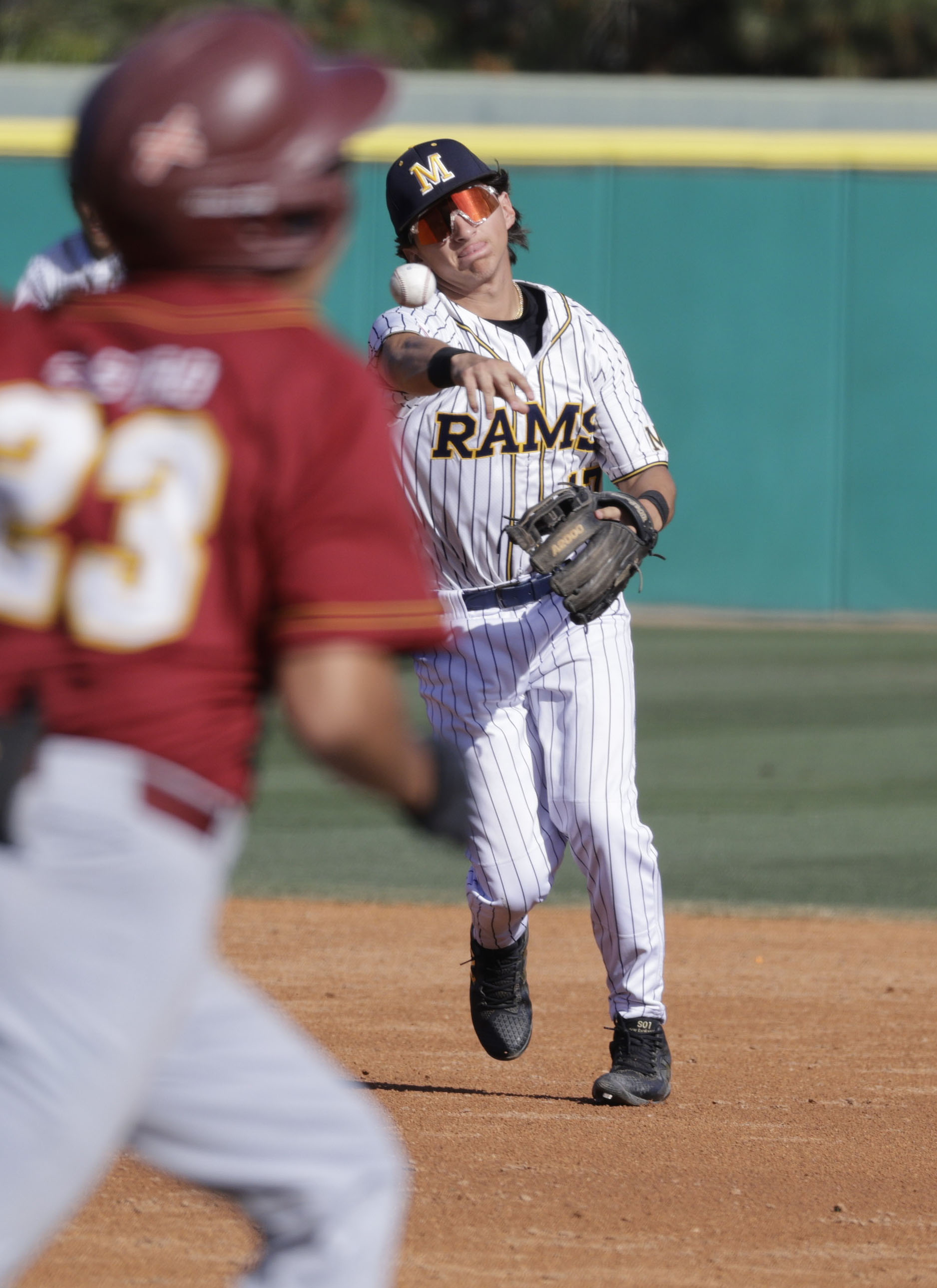 Millikan’s Adrian Ramirez (17) throws to get Wilsons Cesar Castro...