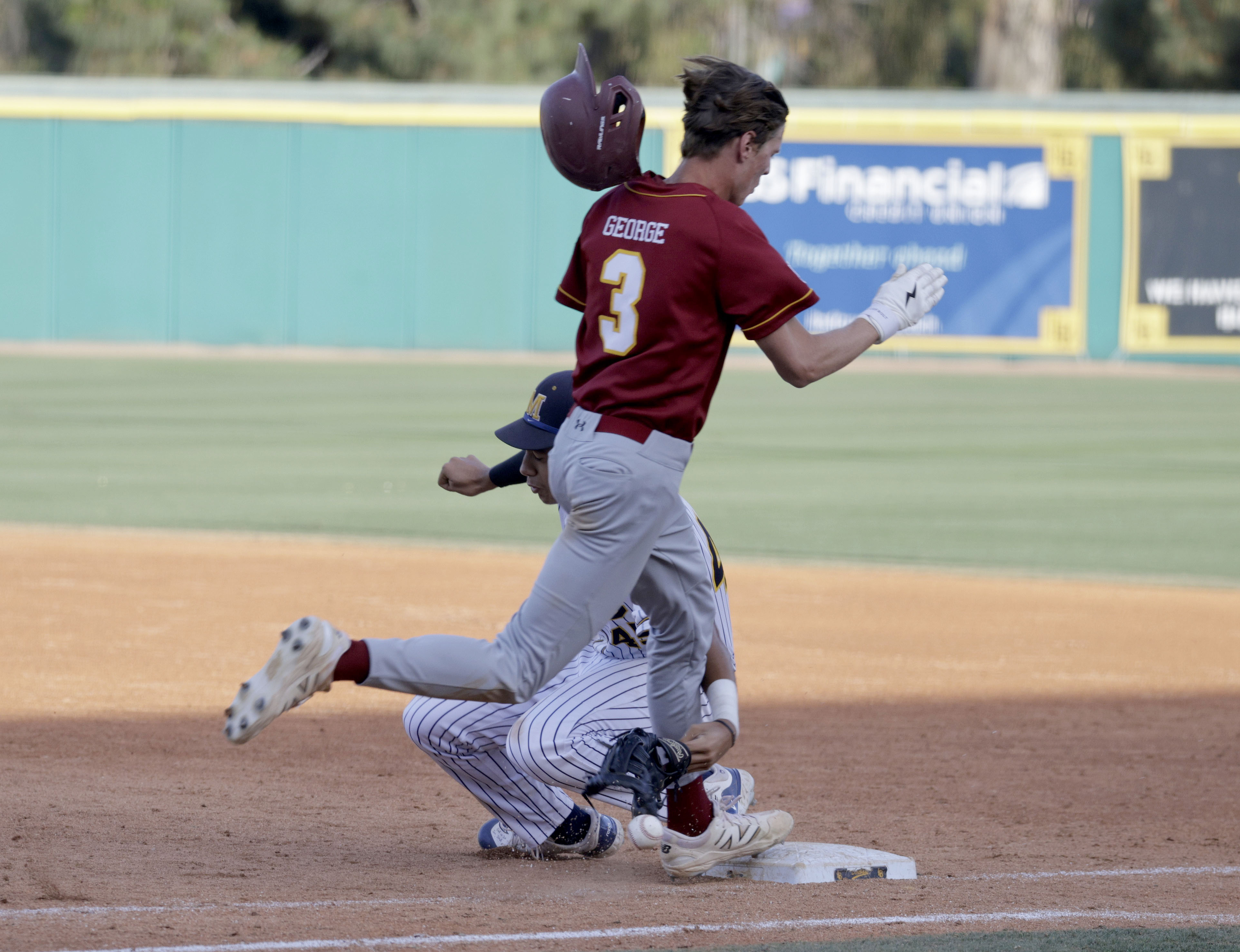 Wilson’s Cooper George (3) is safe at first as Millikans...