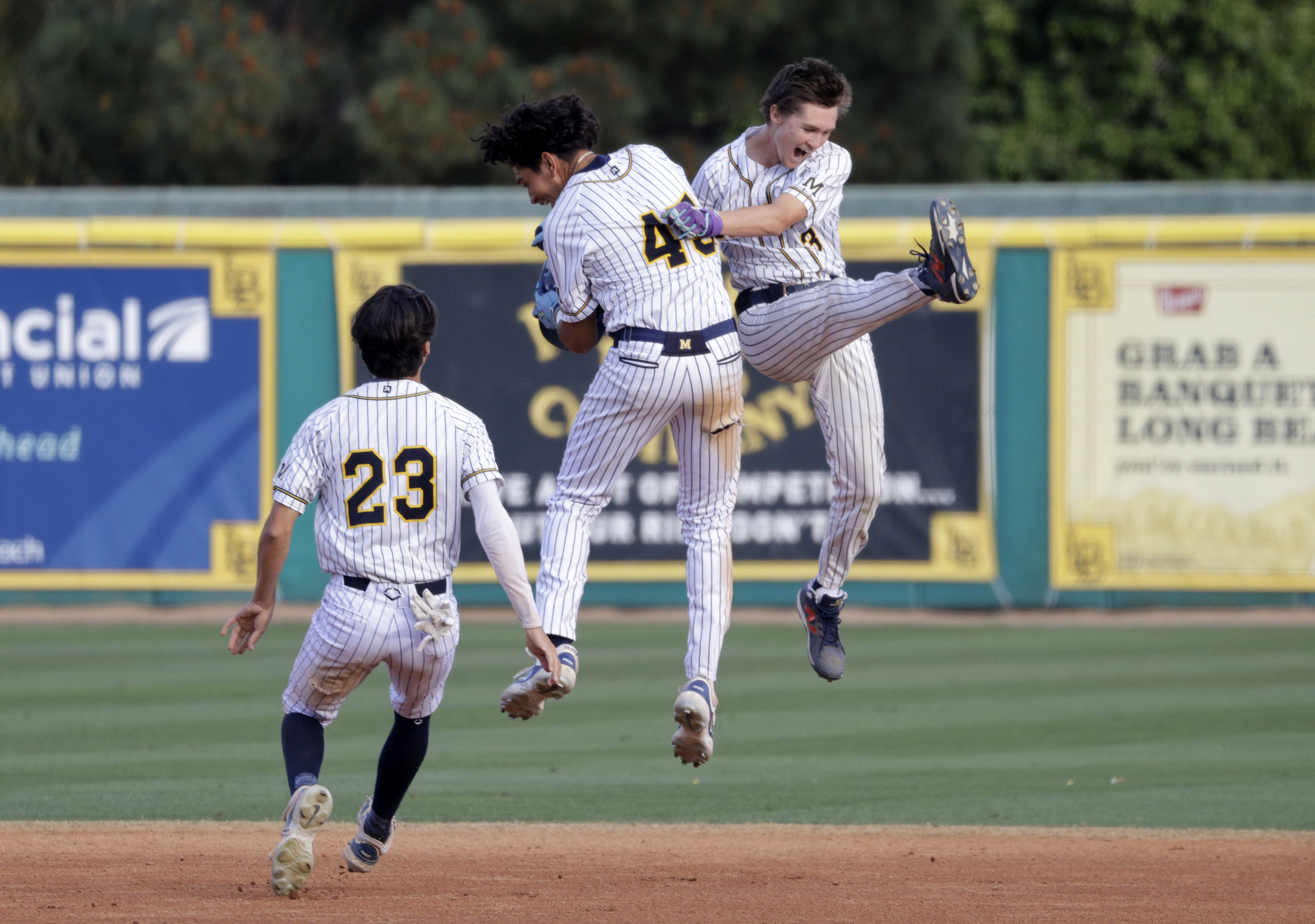Millikan’s Xavier Kennard (23), AJ Nonto (45), and Maison Crommie...