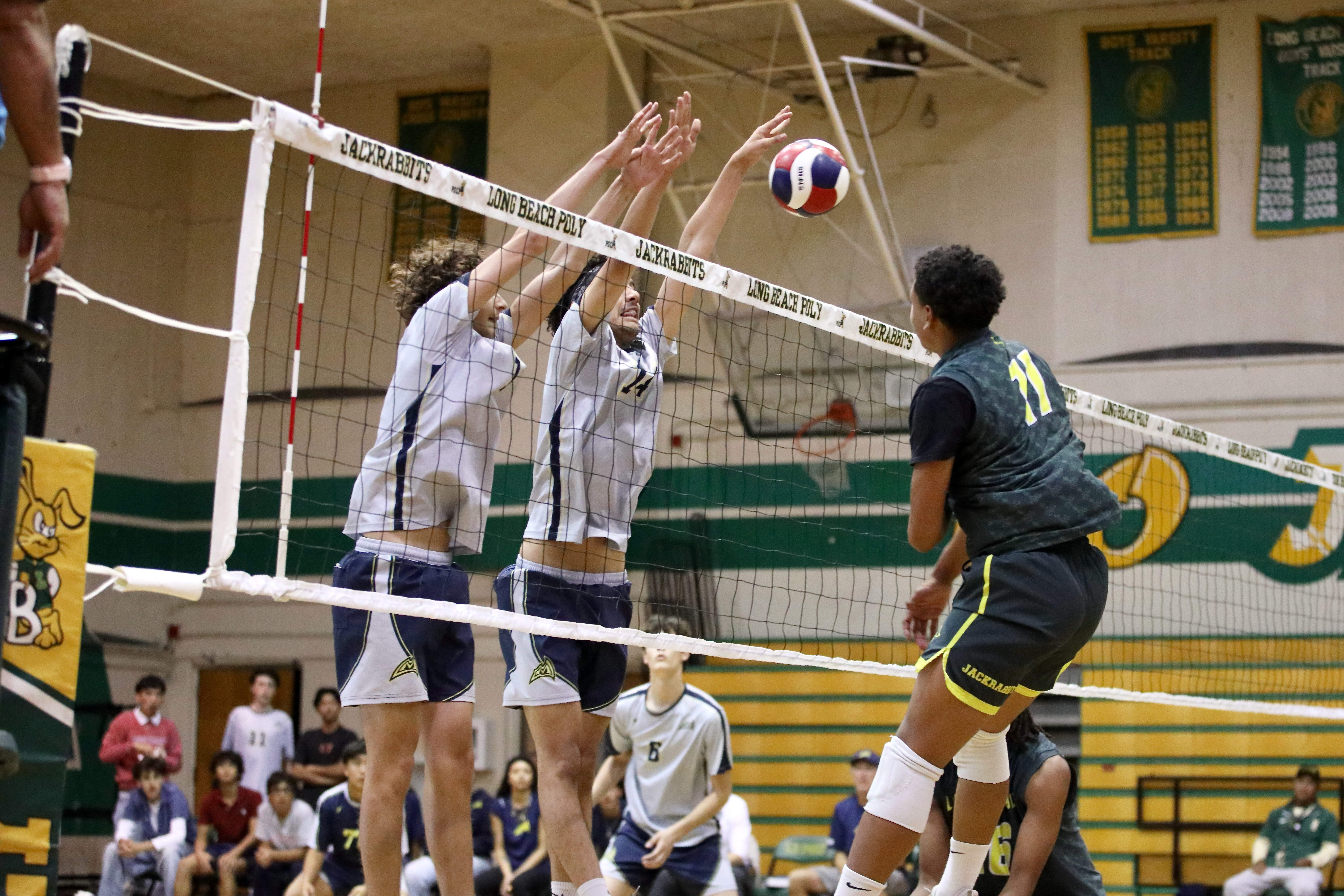 Millikanâs Jacob Karkanen, left, and Andre Medina defend the net...