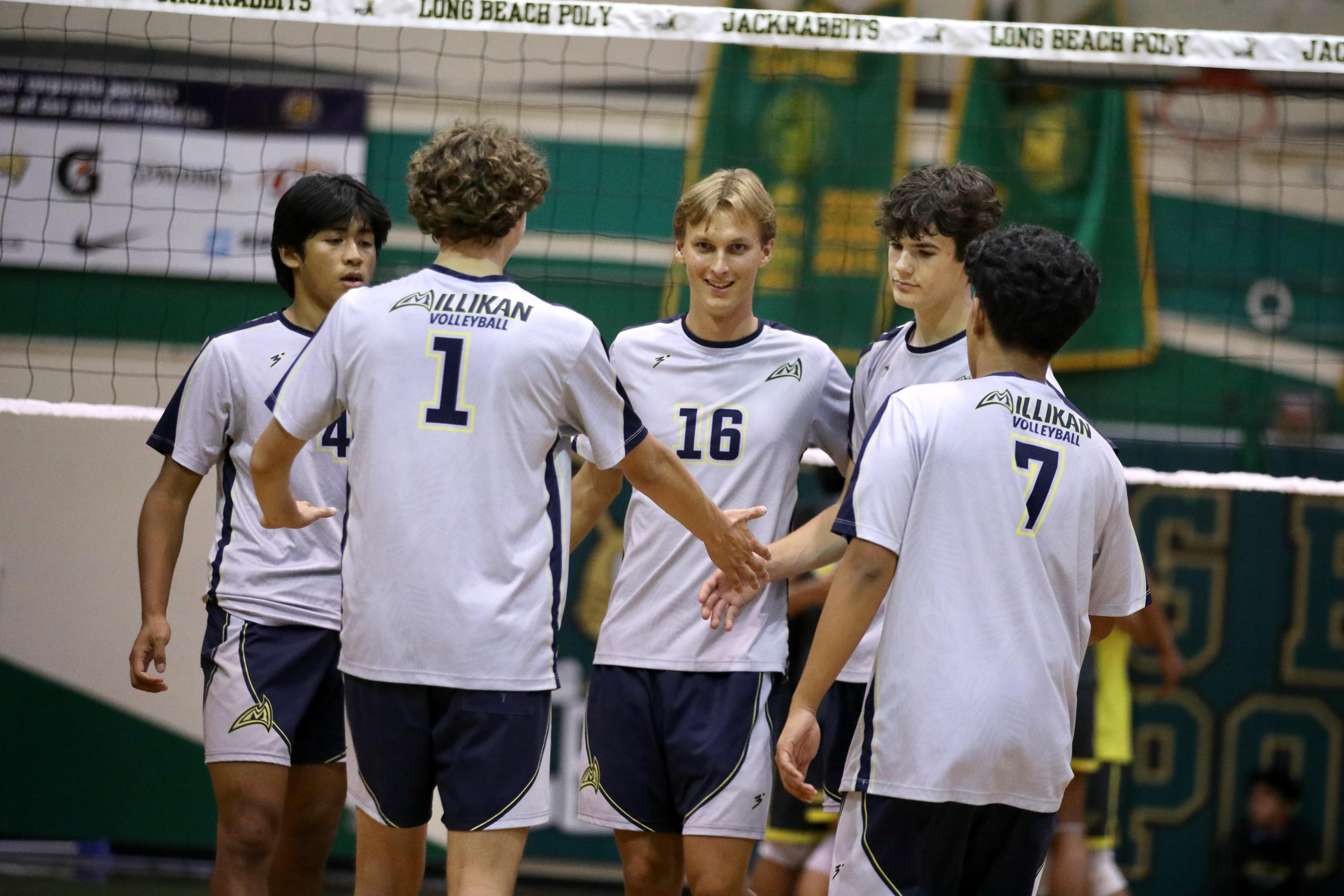 Millikan players gather around Evan Crucil Chambers, center, after a...