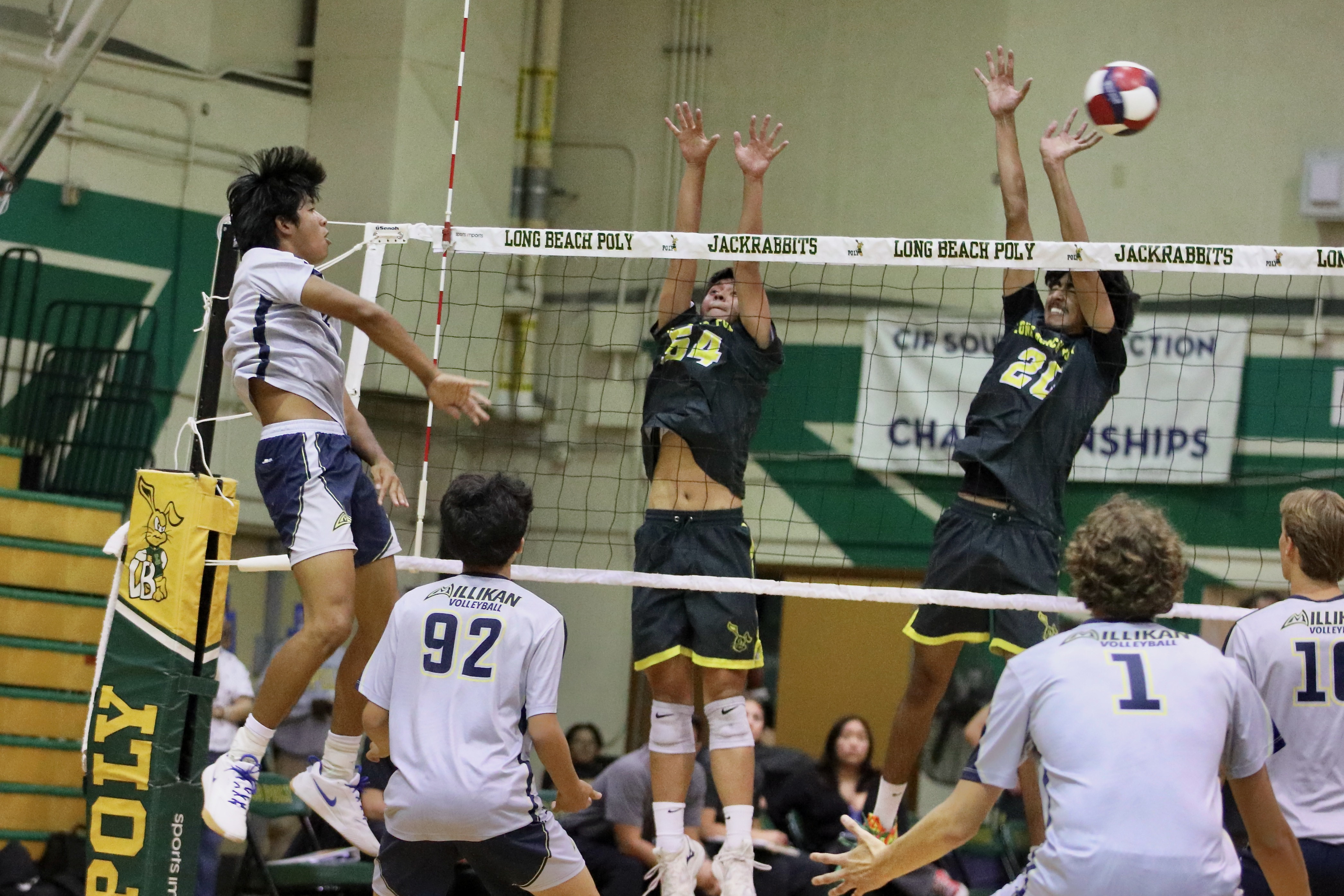 Millikan senior outside hitter Kobe Magdael, from left, gets a...