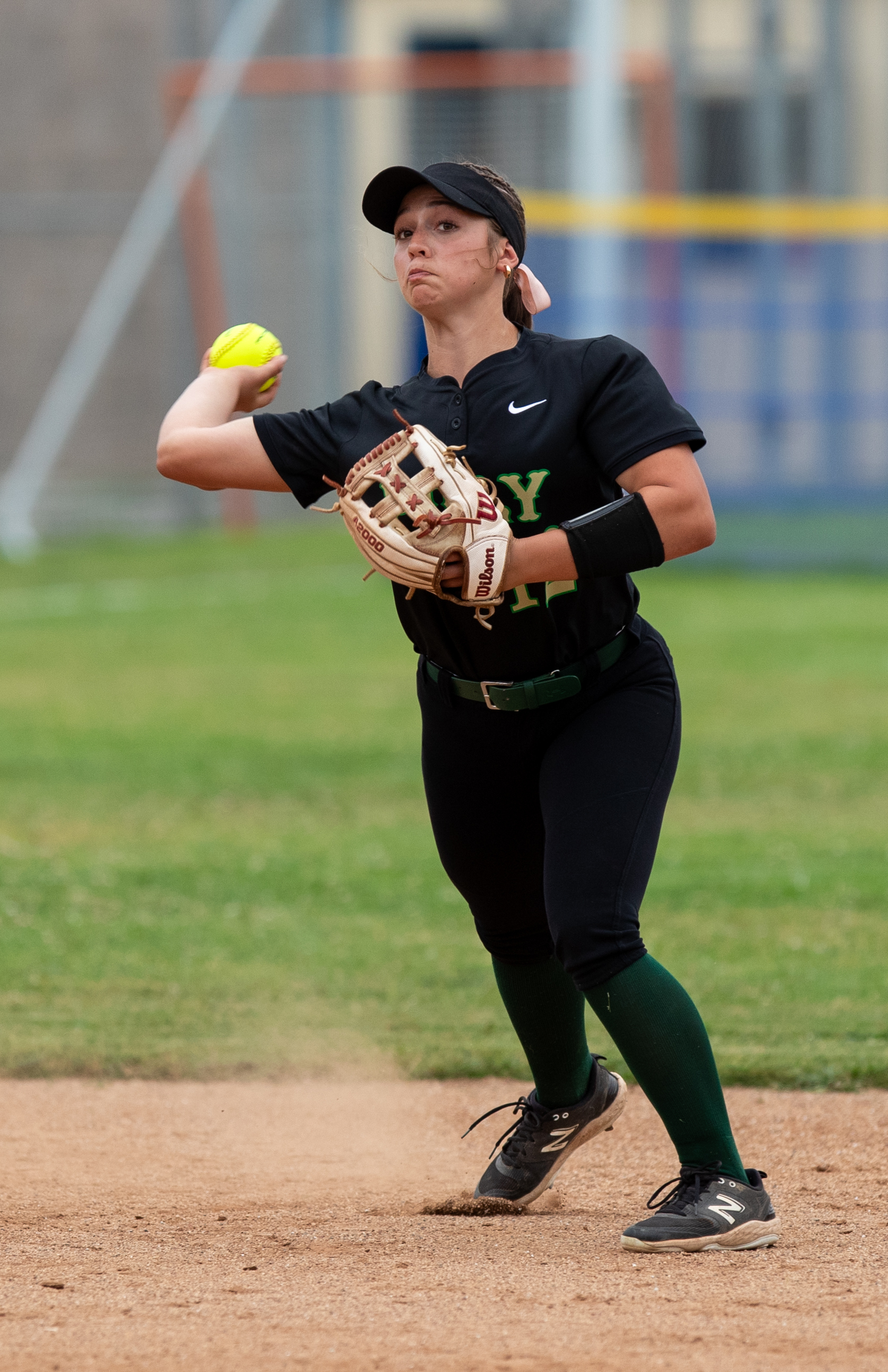 Long Beach Polyâs shortstop Bailey Holder throws to first base...