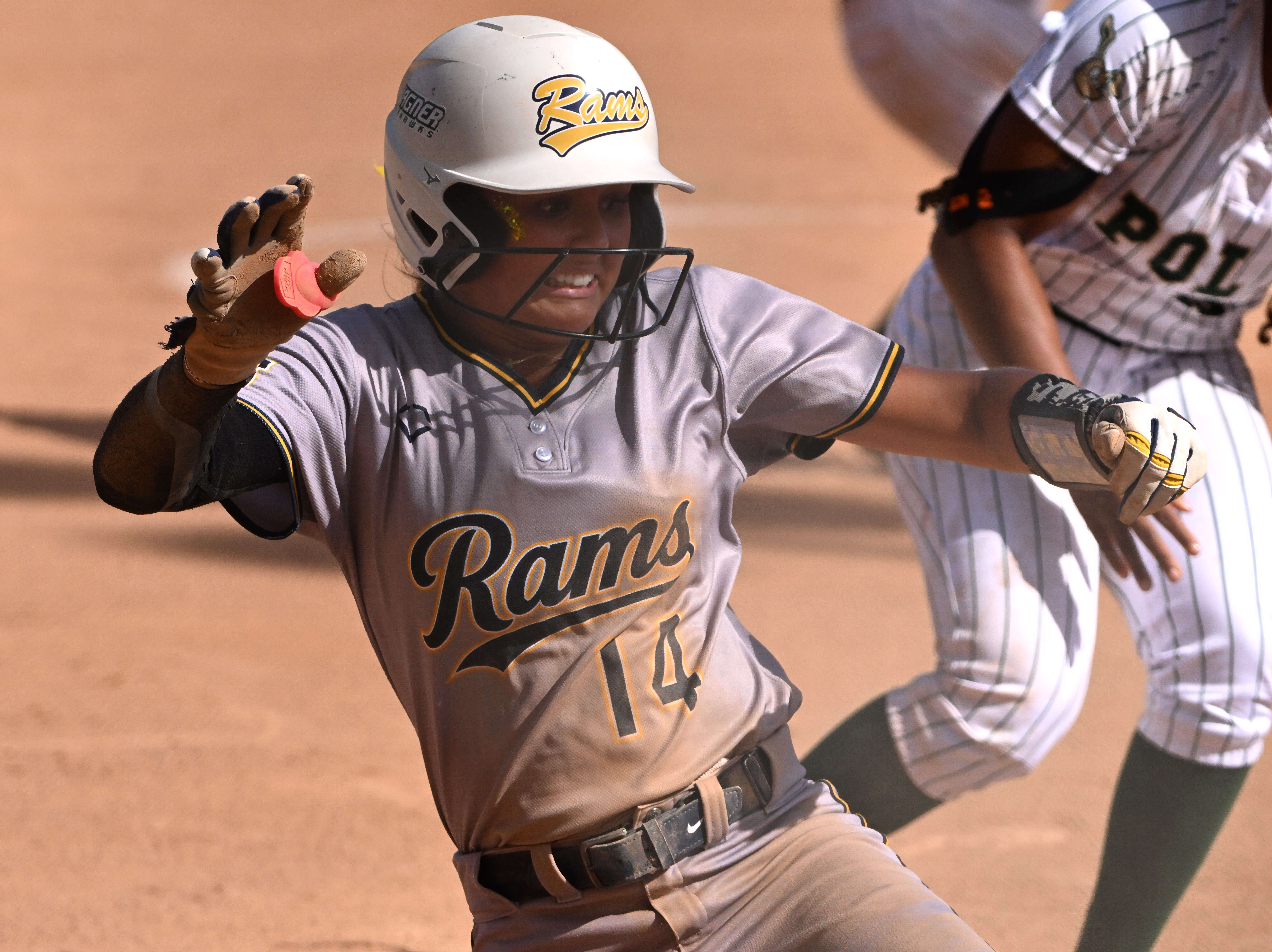 Kayla Cisneros #14 of the Millikan Rams tagged out by...