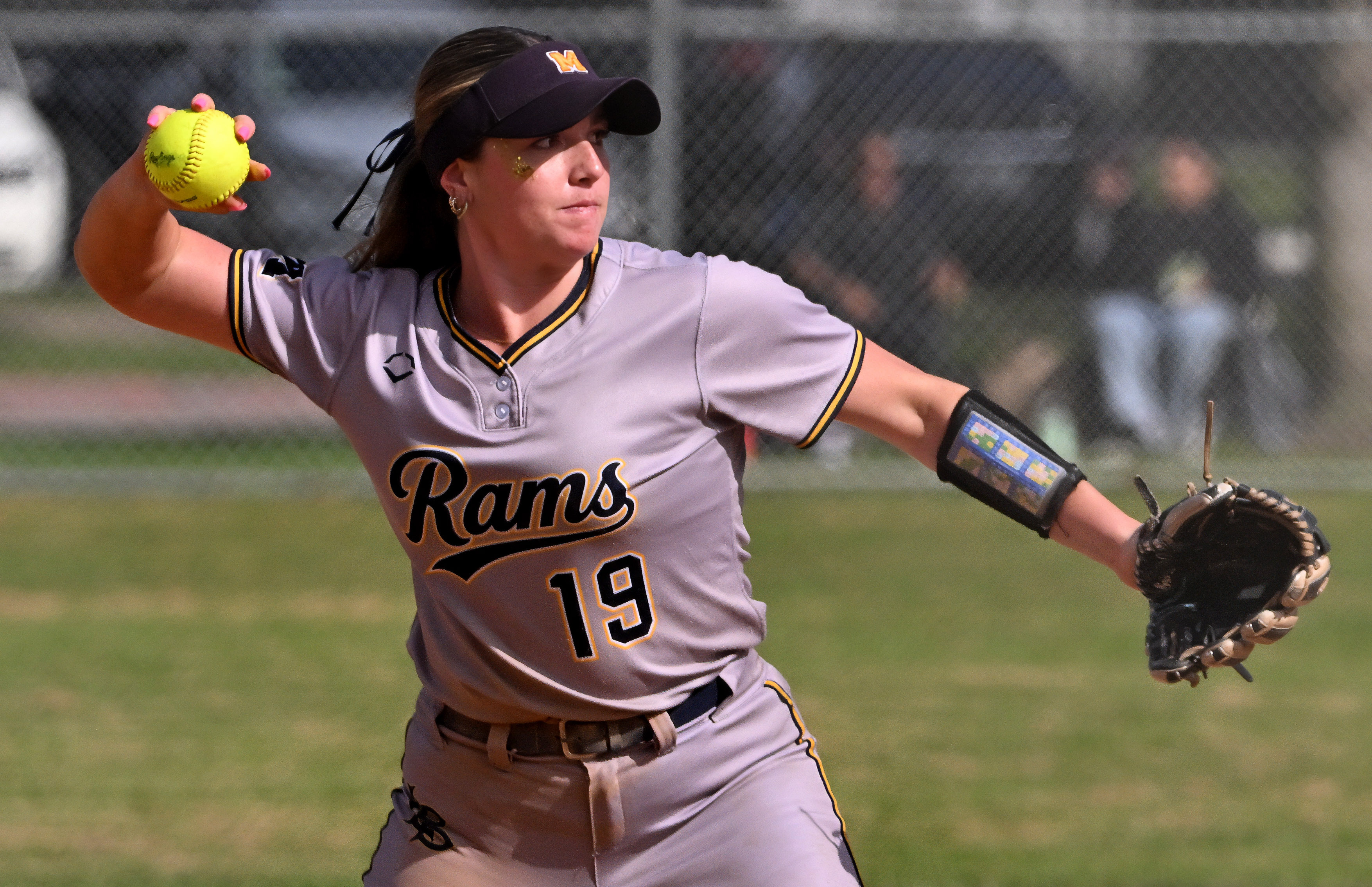 Third baseman Addy Everrett #19 of the Millikan Rams throws...