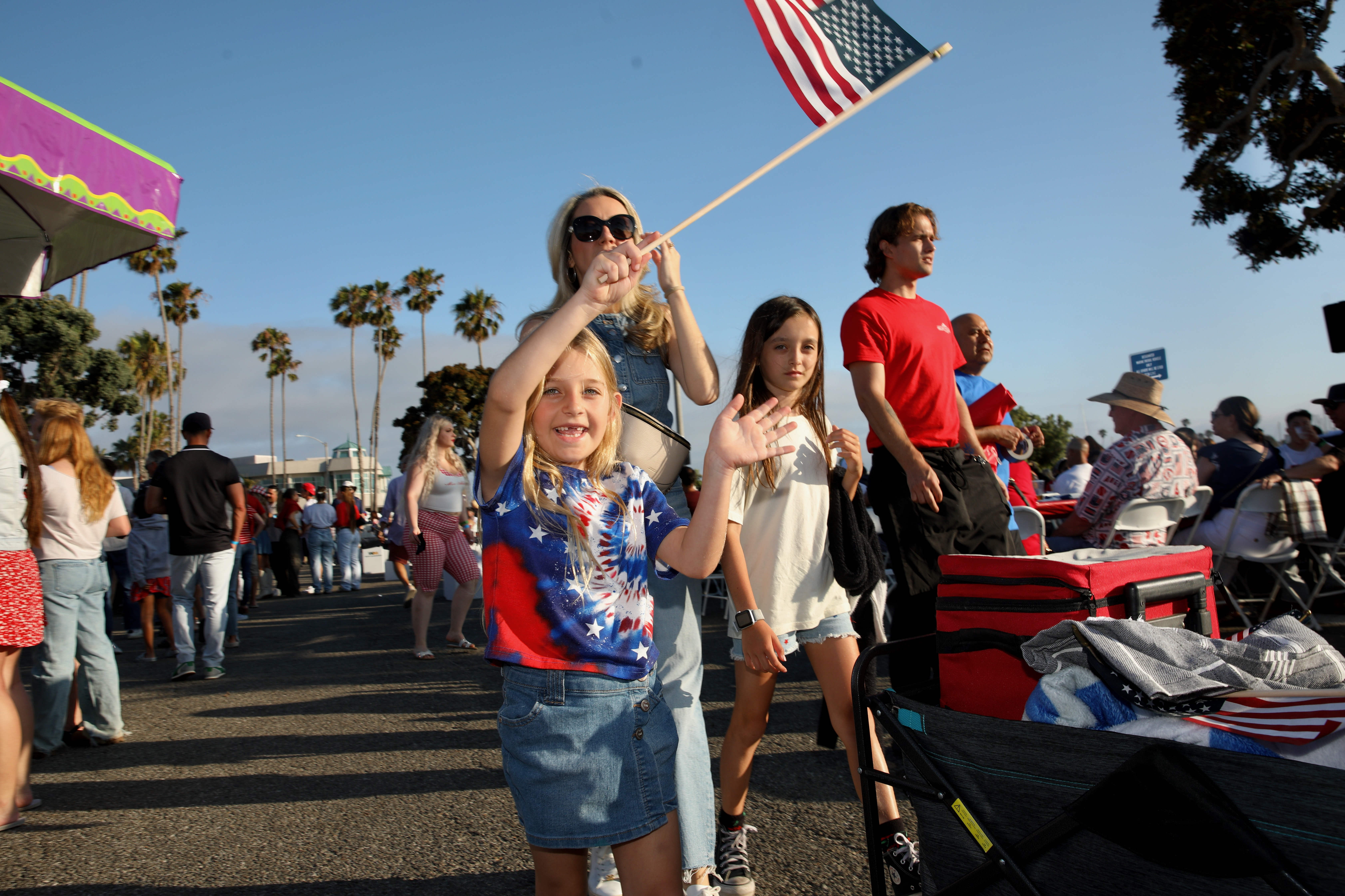 A young reveler waves an American flag at the Big...