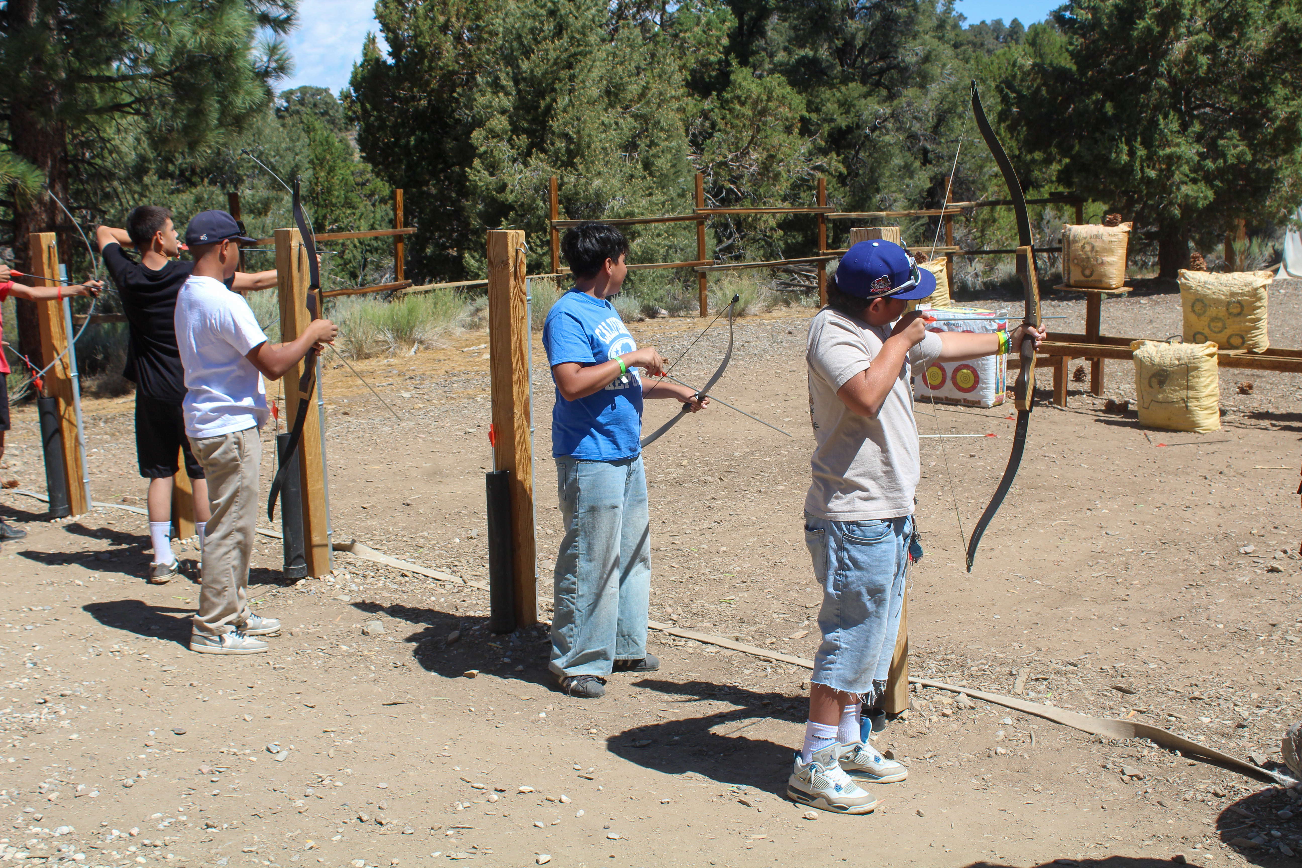 Long Beach youth learn how to shoot an arrow at...