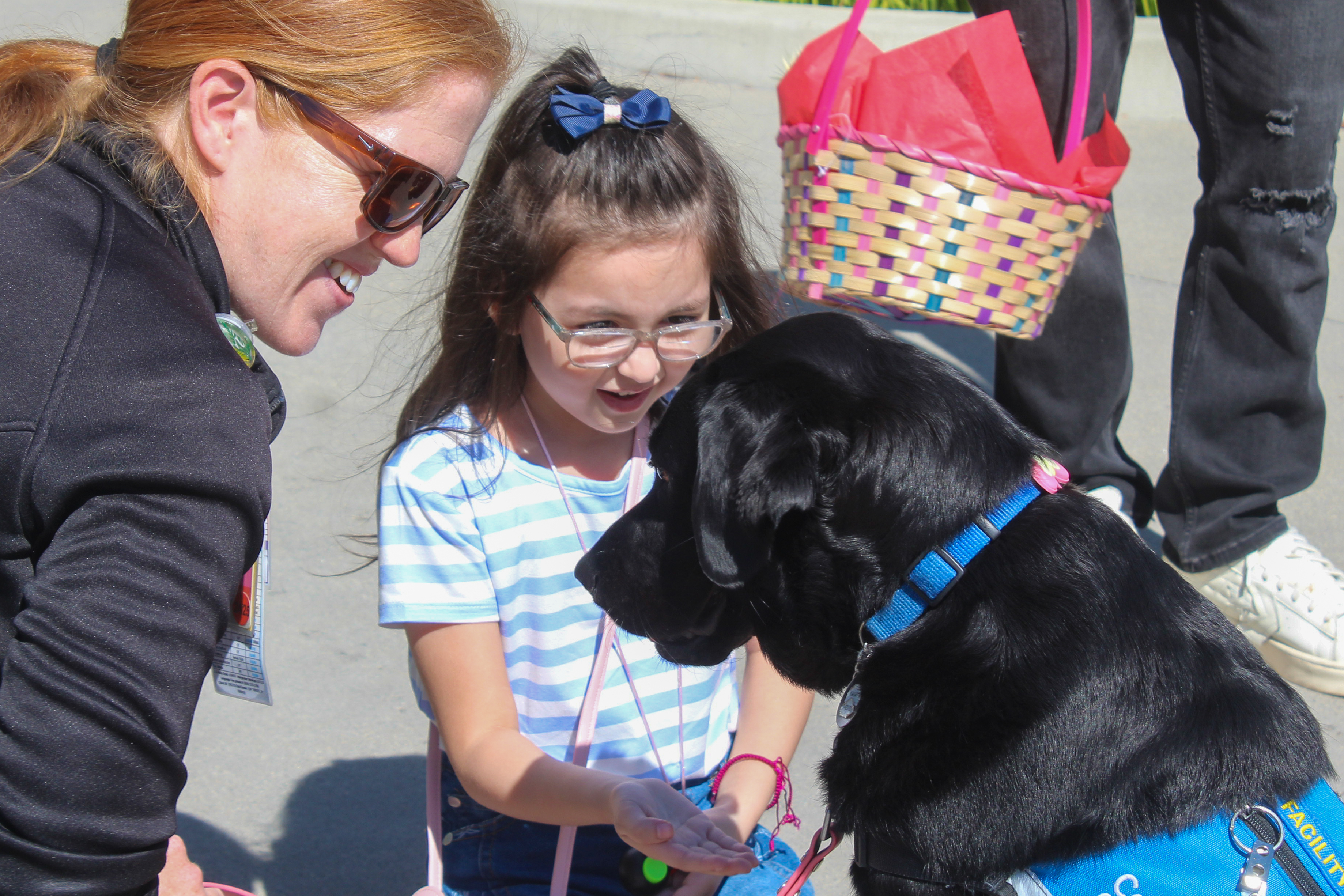 Liani Lira, 5, petting Miller Children’s & Women’s Hospital facility...