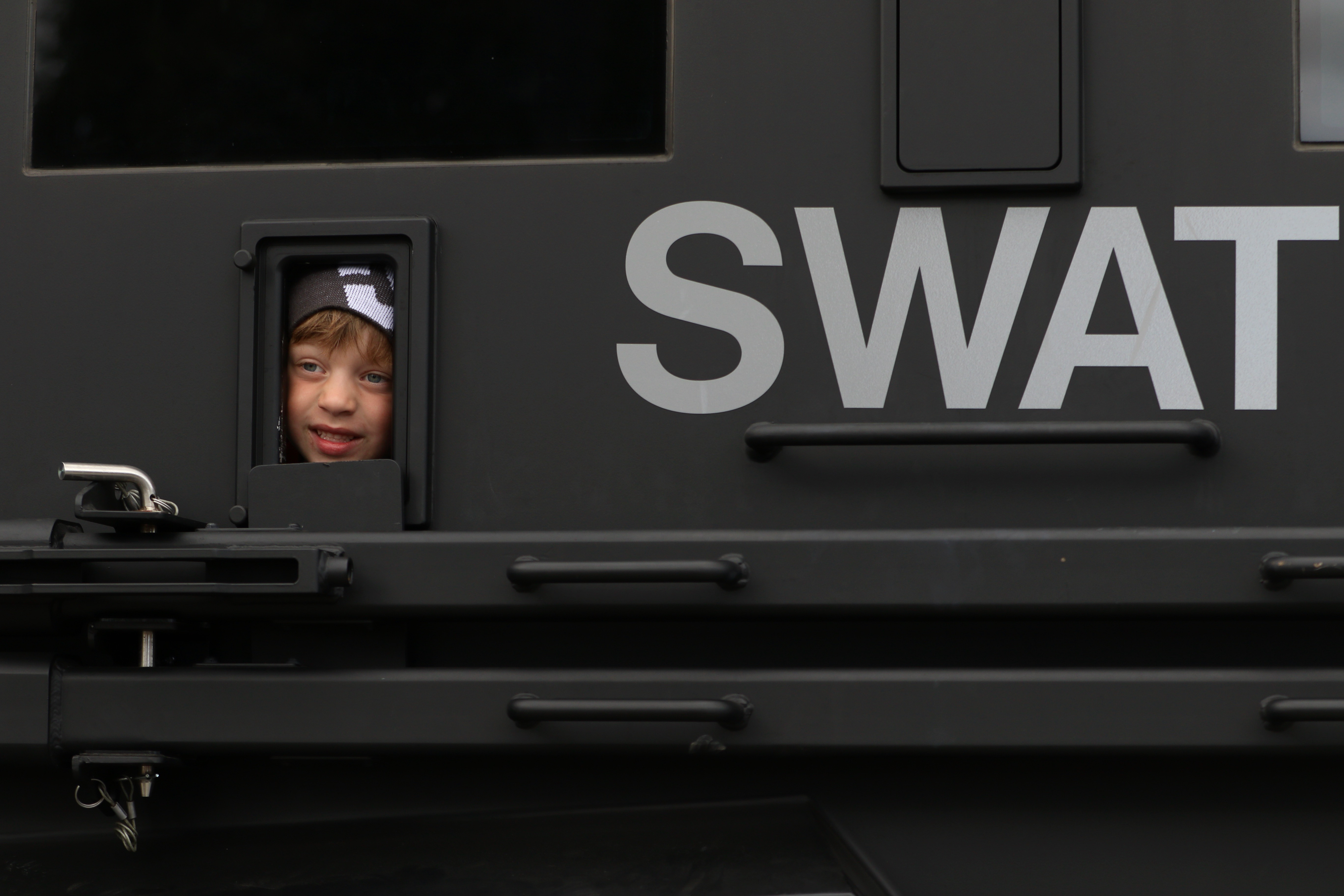Logan Woolley, 4, peeks out the window of a Long...