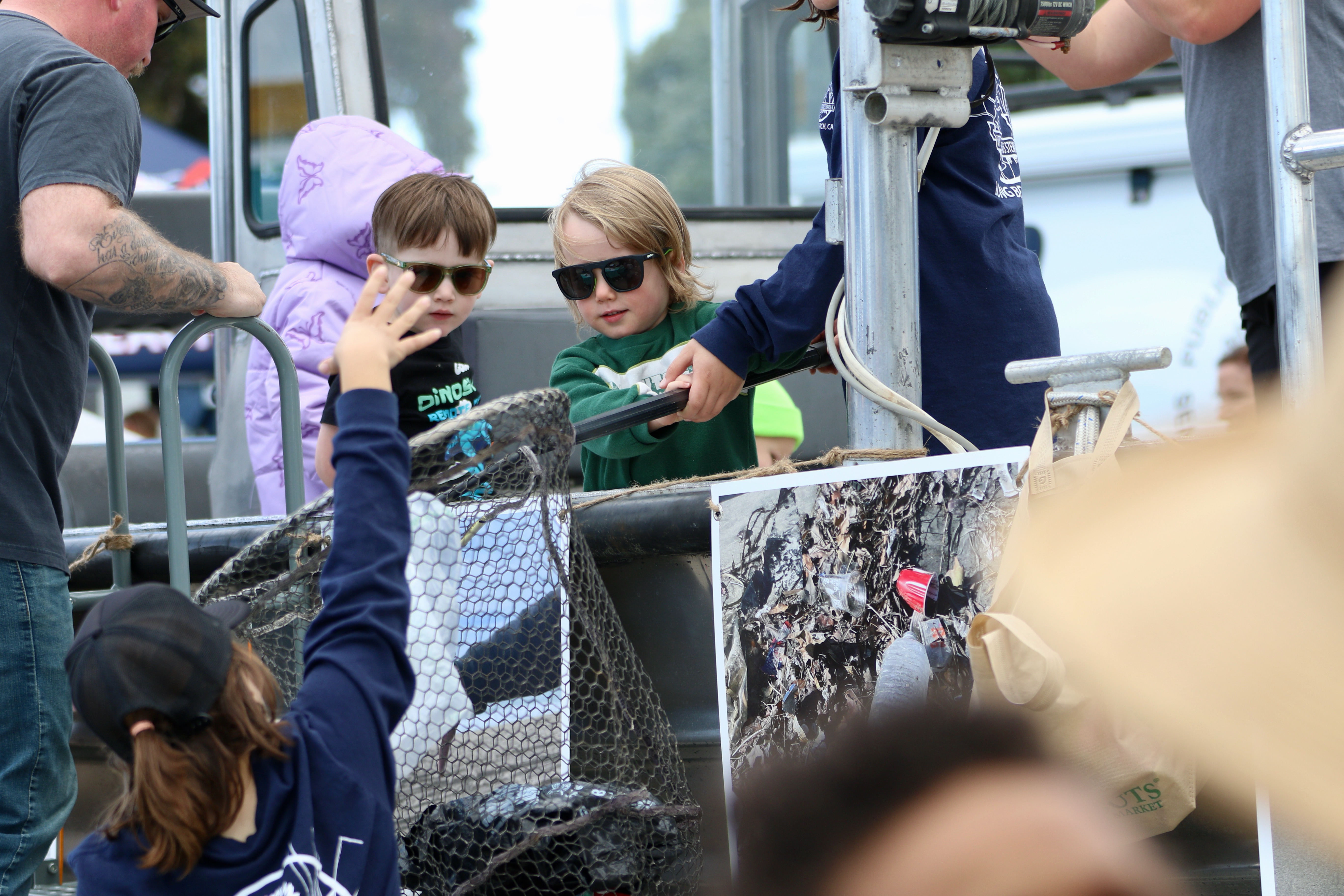 Youngsters are taught how to collect trash in a dip...