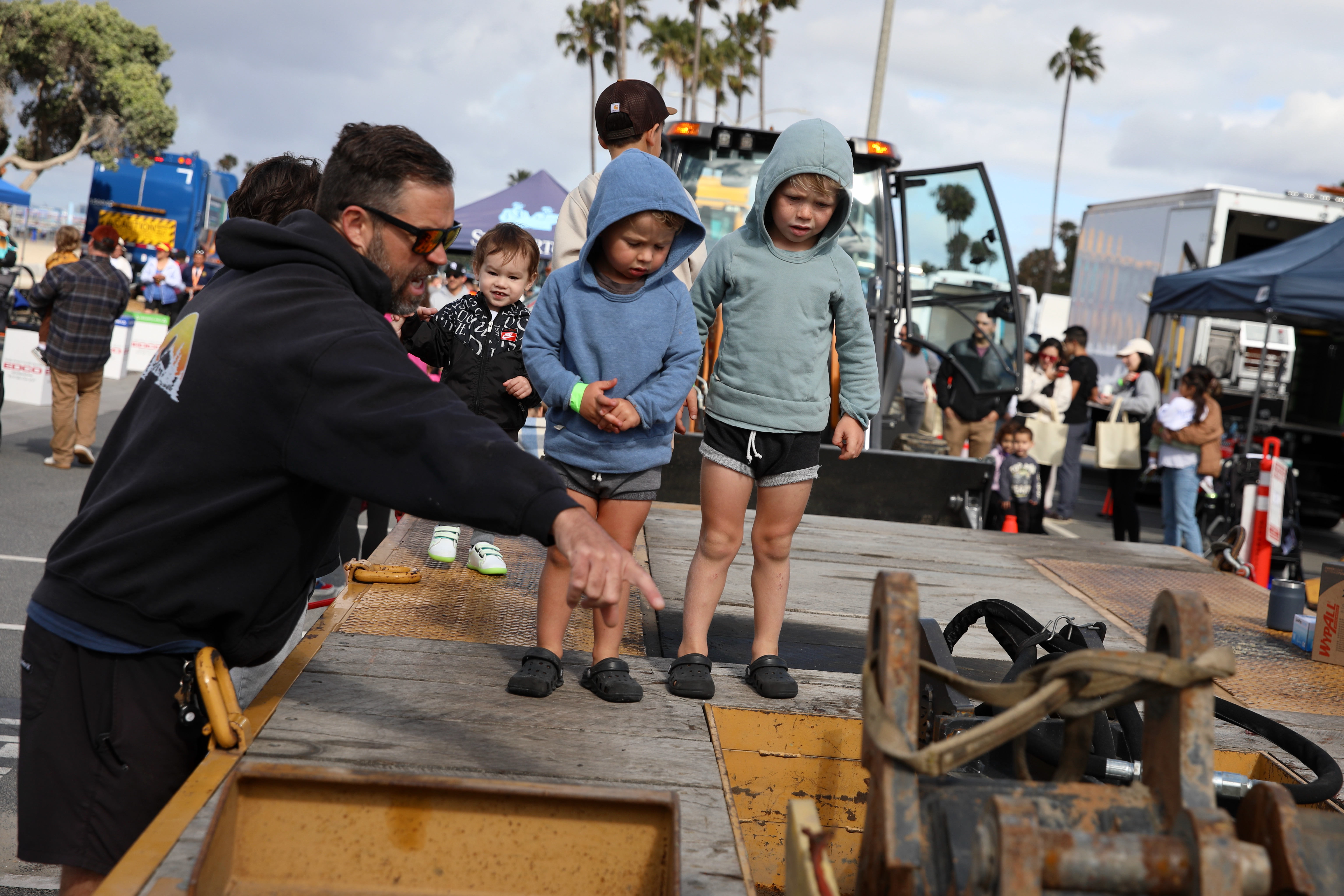 Young visitors board a tow truck at the annual Touch-A-Truck...