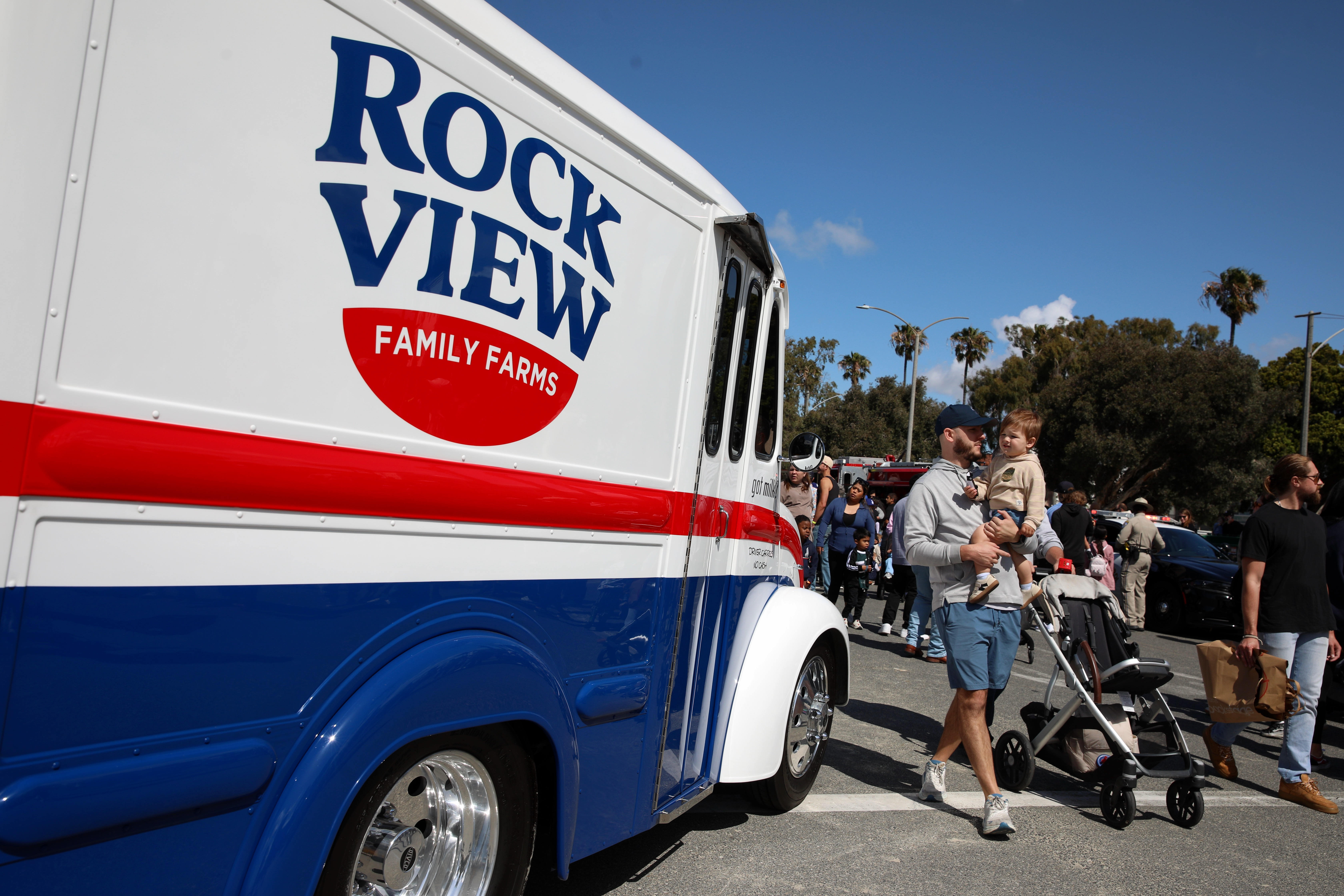 Visitors pass a vintage milk truck at the annual Touch-A-Truck...