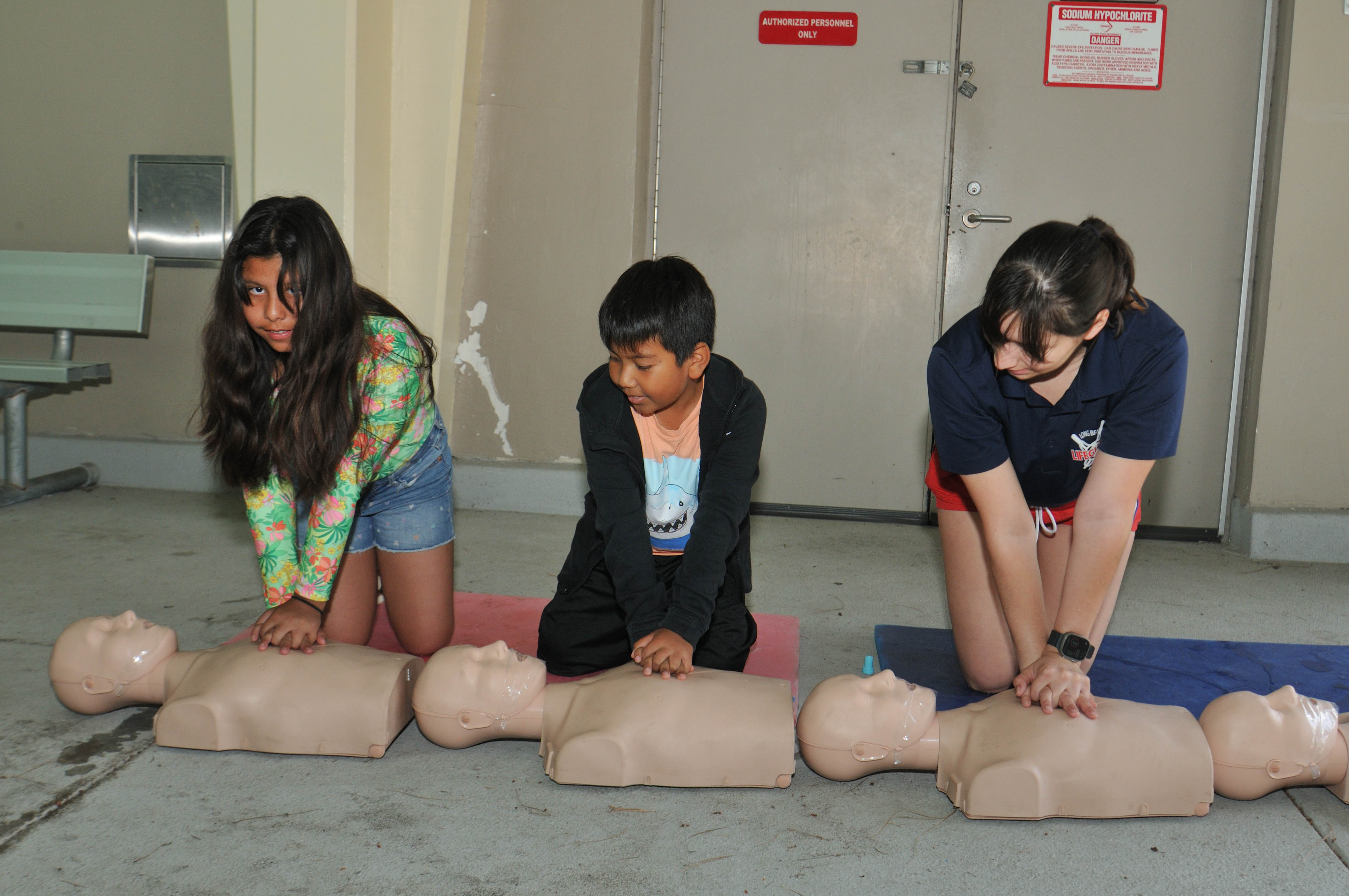 Children practice life-saving skills and learn water safety tips during...