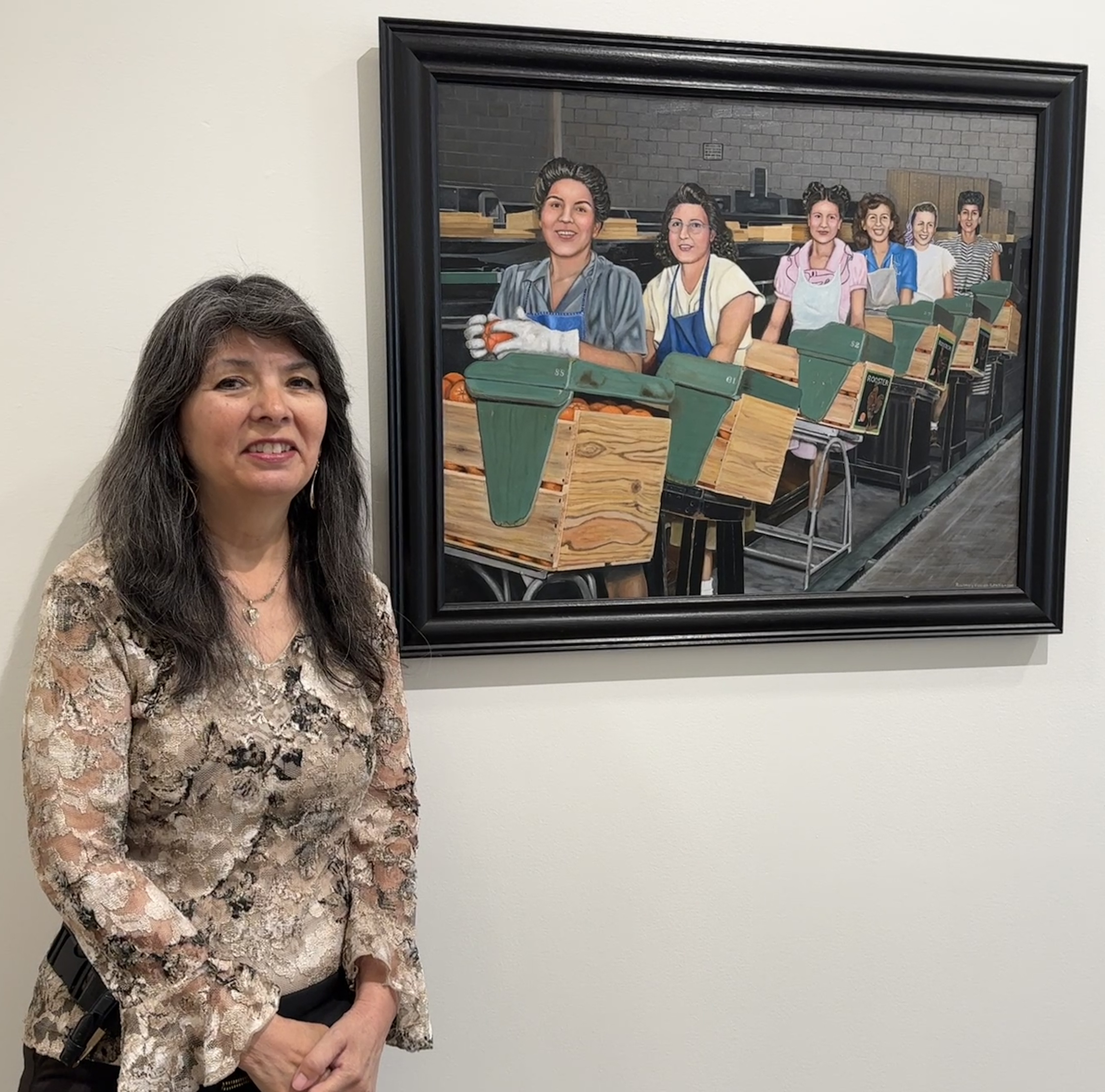 Rosemary Vasquez Tuthill stands next to a painting she finished...