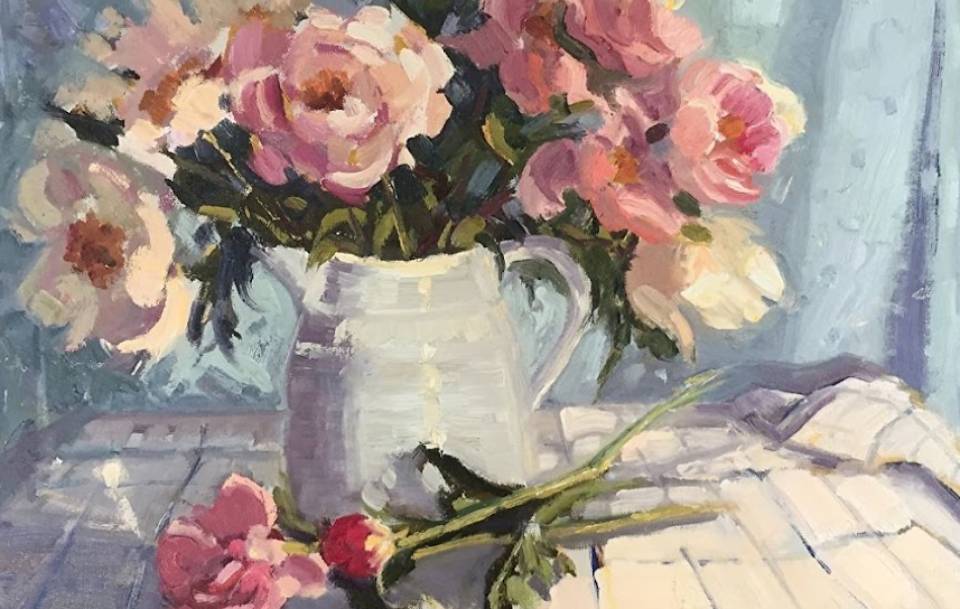 painting of pink and cream flowers in a white pitcher on table
