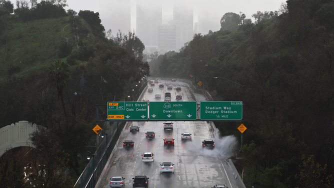 LOS ANGELES, CALIFORNIA - FEBRUARY 06: Vehicles travel toward downtown as rain continues to fall during the morning commute as a powerful long-duration atmospheric river storm, the second in less than a week, continues to impact Southern California on February 6, 2024 in Los Angeles, California. Over seven inches of rain have fallen in downtown Los Angeles during the storm, half the average yearly total. The storm has delivered widespread flooding, landslides and power outages while dropping heavy rain and snow across the region. (Photo by Mario Tama/Getty Images)