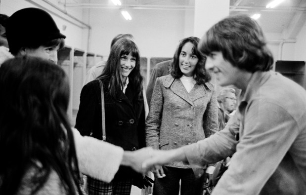 George Harrison of the Beatles meets the Baez sisters, from left, Pauline, Mimi and Joan. (Photo by Jim Marshall)