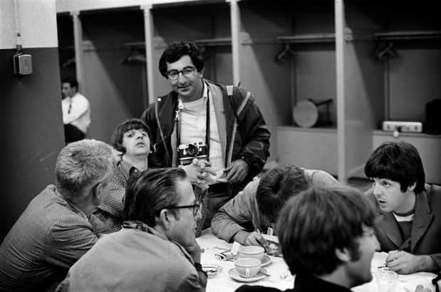 Rock photographer Jim Marshall, standing, pictured with members of the Beatles before their show at San Francisco's Candlestick Park in 1966. (Courtesy of Jim Marshall)