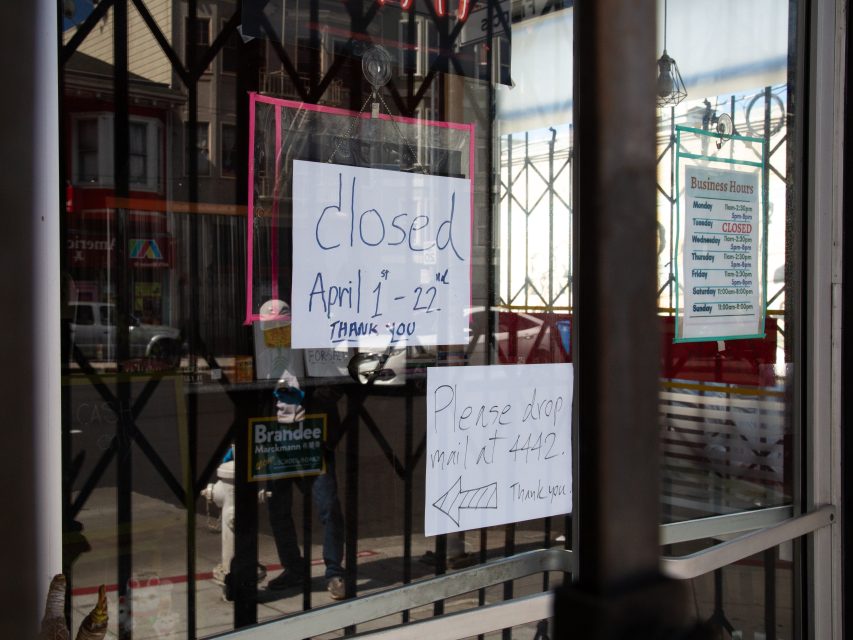 A storefront window displays handwritten signs stating the business is closed from April 1–22 and instructing to drop mail at unit #442.