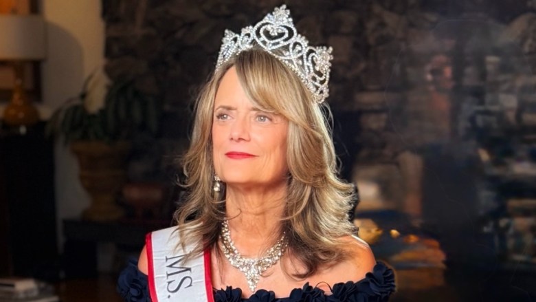 A woman with a sash and a crown
