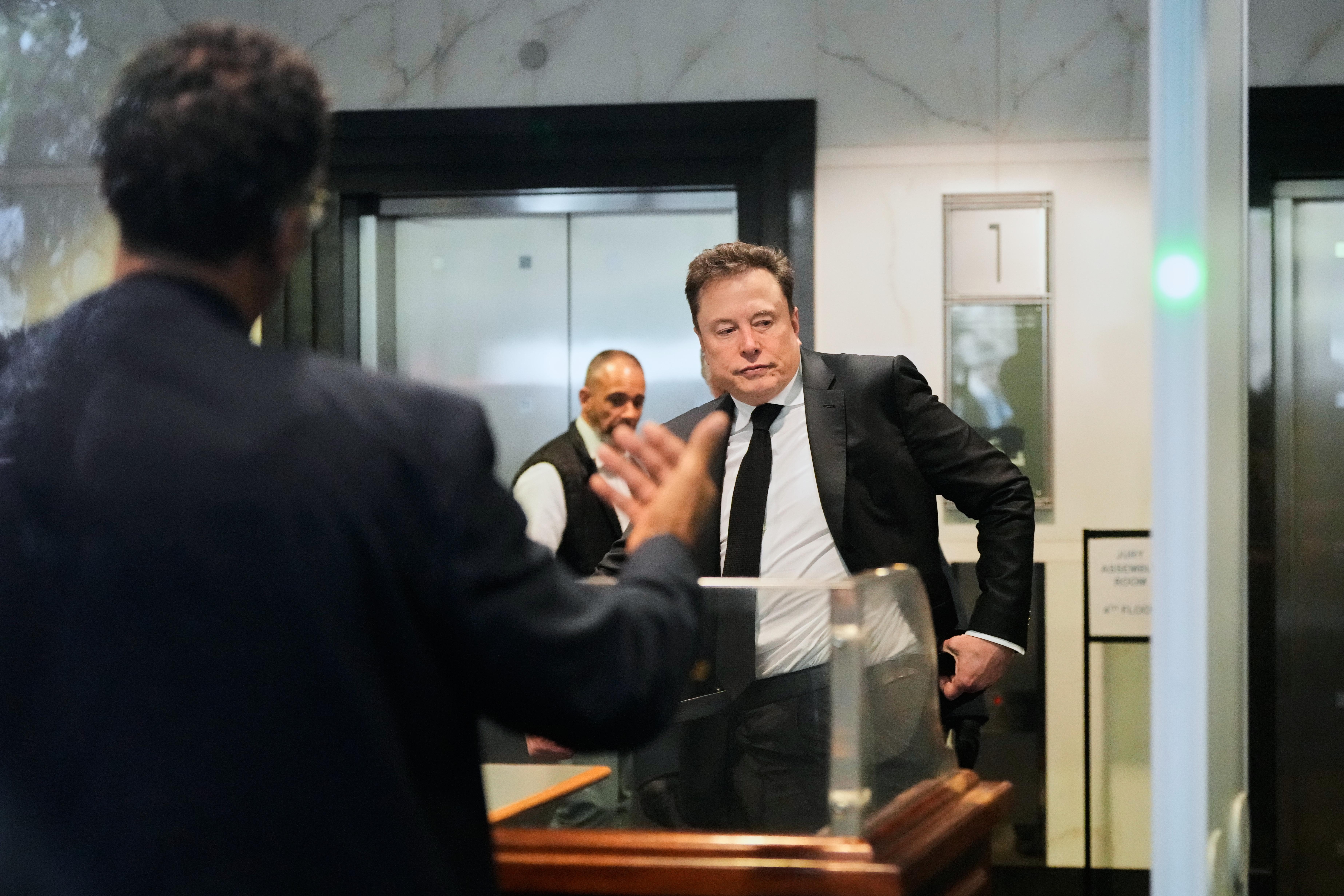 Elon Musk arrives at the U.S. District Court in Oakland,...