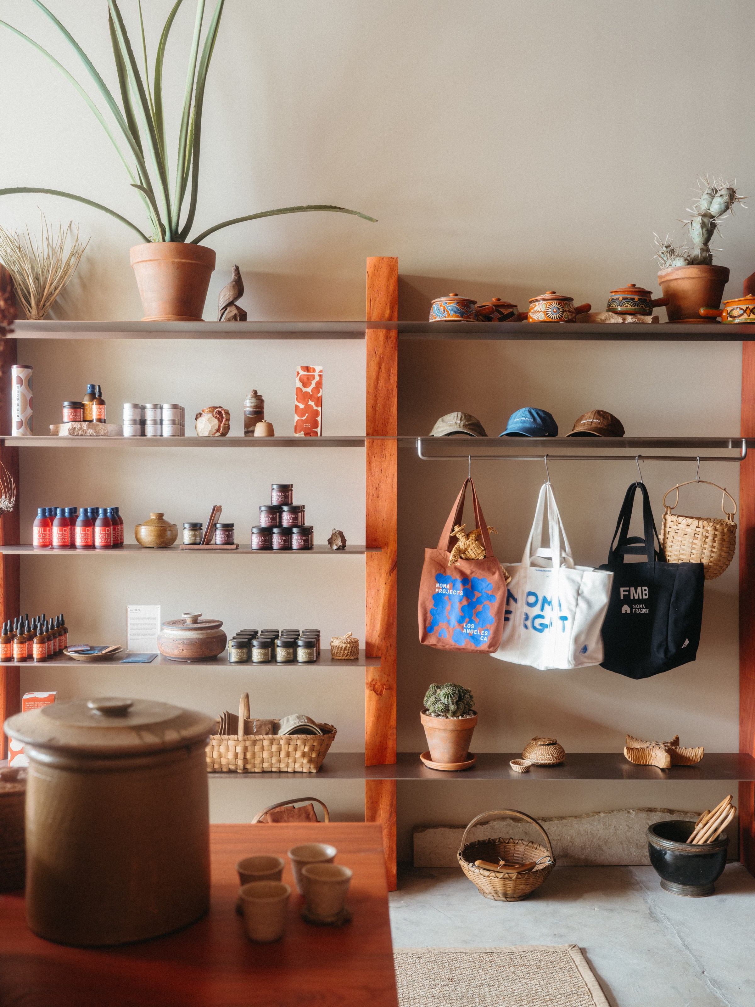 Merchandise on wood shelves at Noma Projects.