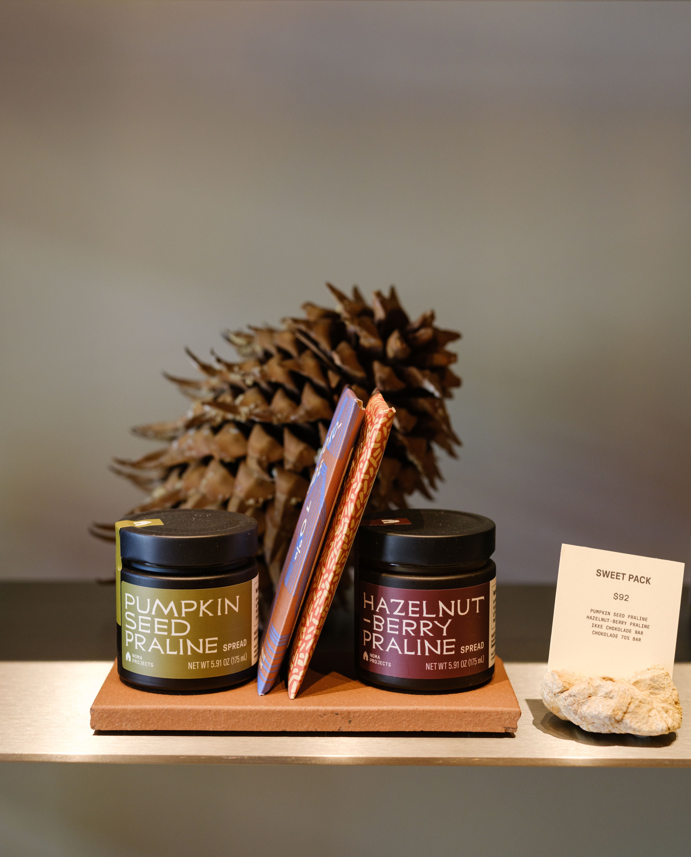 Two spreads and chocolate on a shelf at Noma Projects.