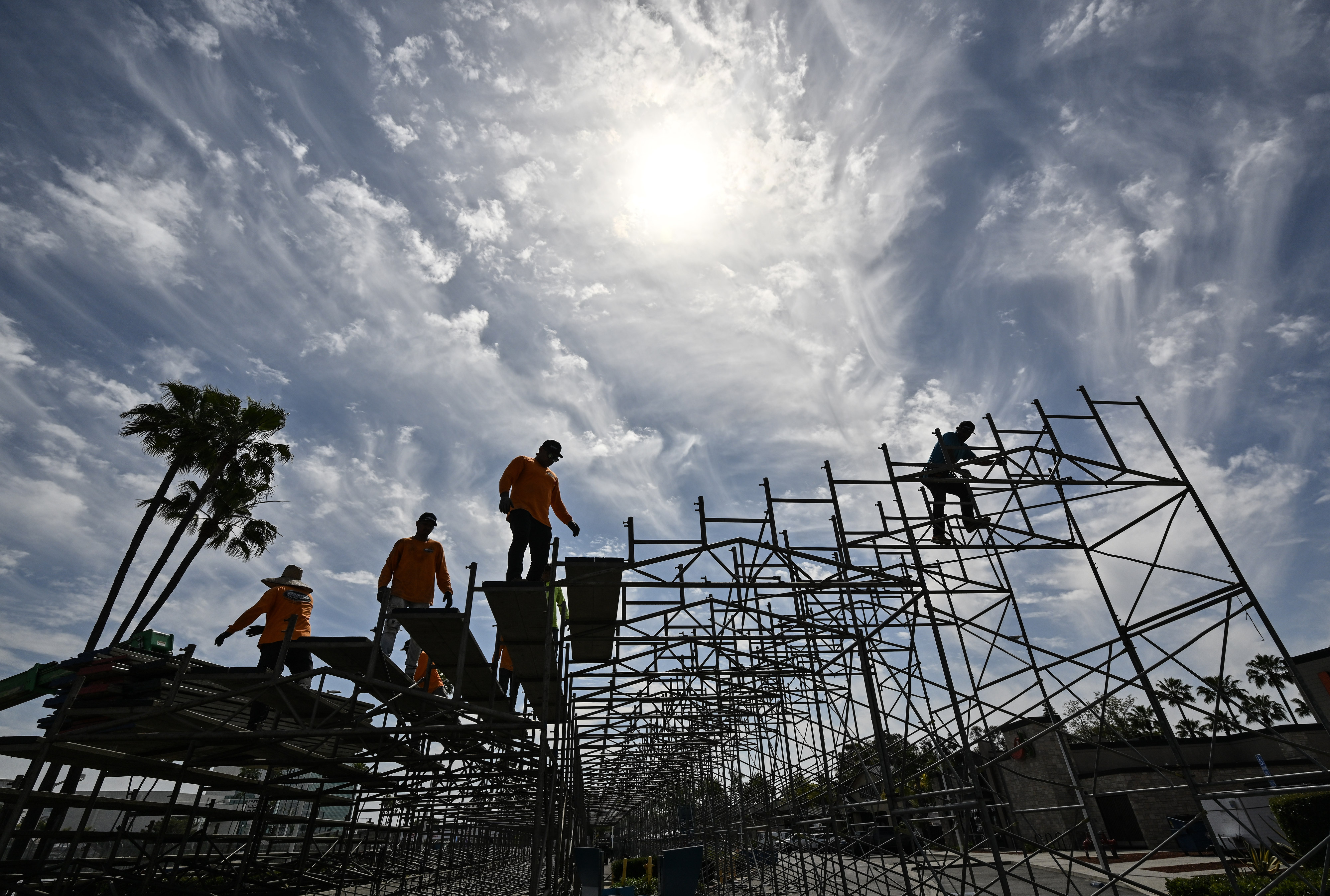Worker dismantle grandstands along Shoreline Drive the day after the...