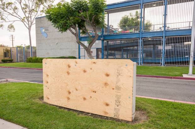 A sheet of plywood covers up the school sign at Cesar E. Chavez High School in Santa Ana on Friday, March 27, 2026. (Photo by Leonard Ortiz, Orange County Register/SCNG)