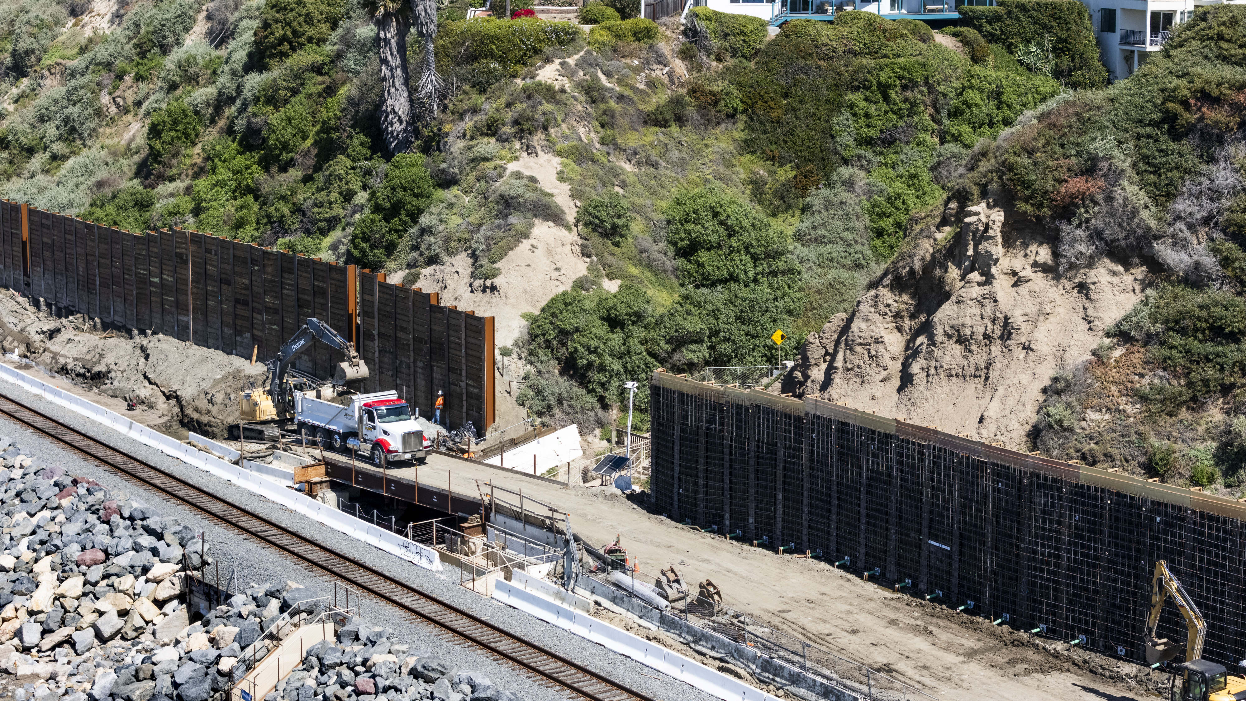 Work continues to secure the hillside and protect train tracks...