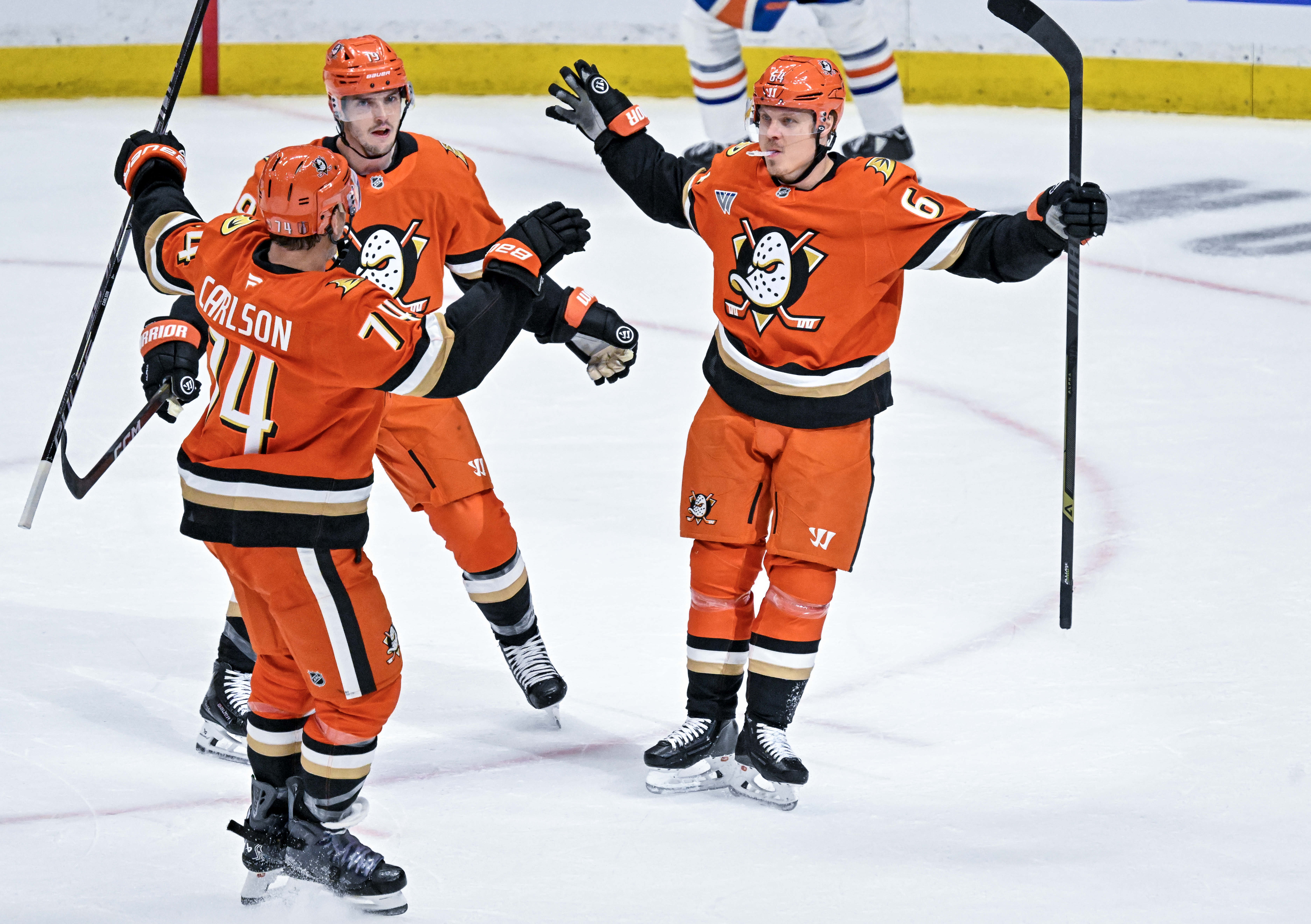 Ducks players celebrate a first period goal by Mikael Granlund...