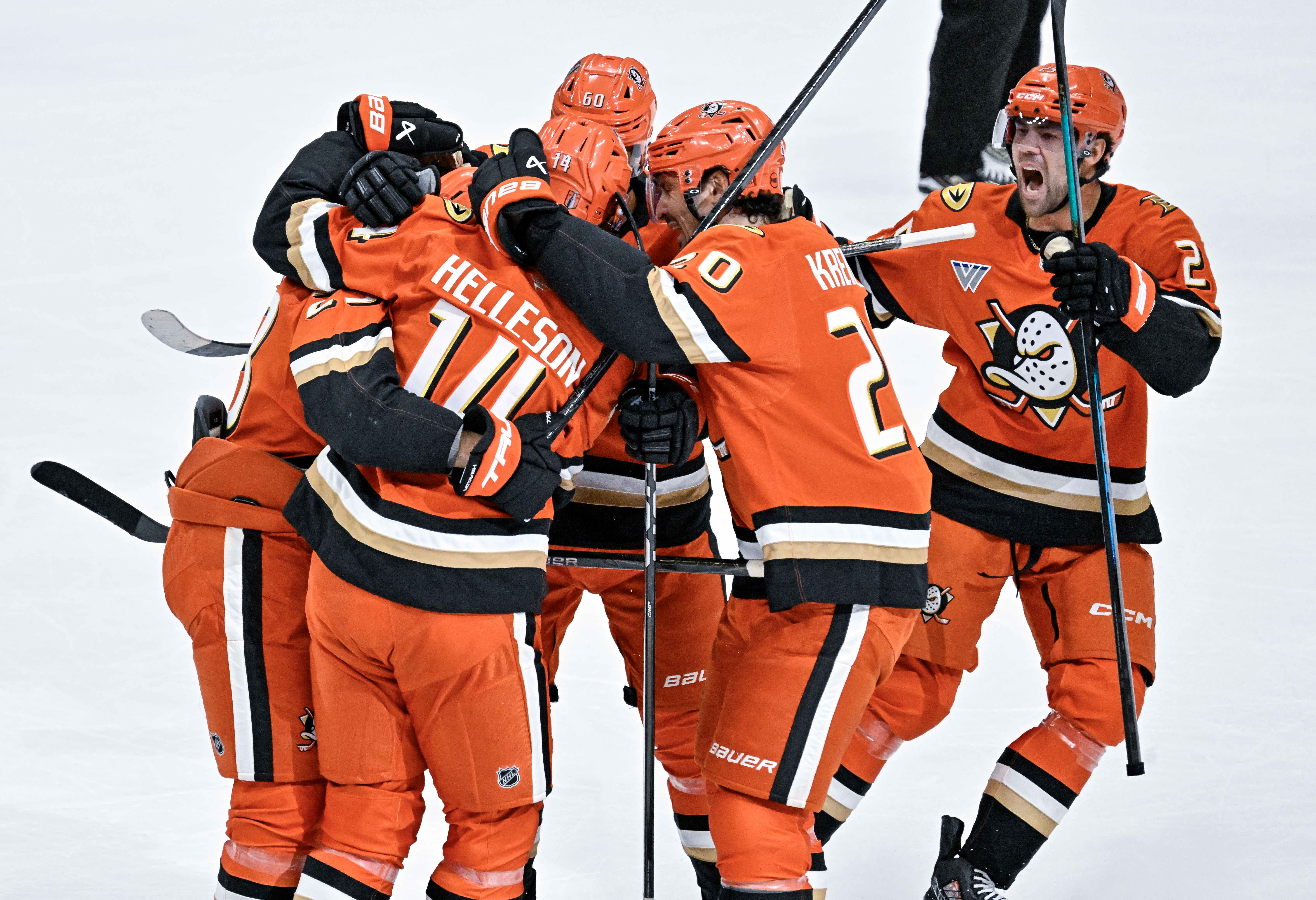 Ducks players celebrate a first-period goal by Mason McTavish (23)...