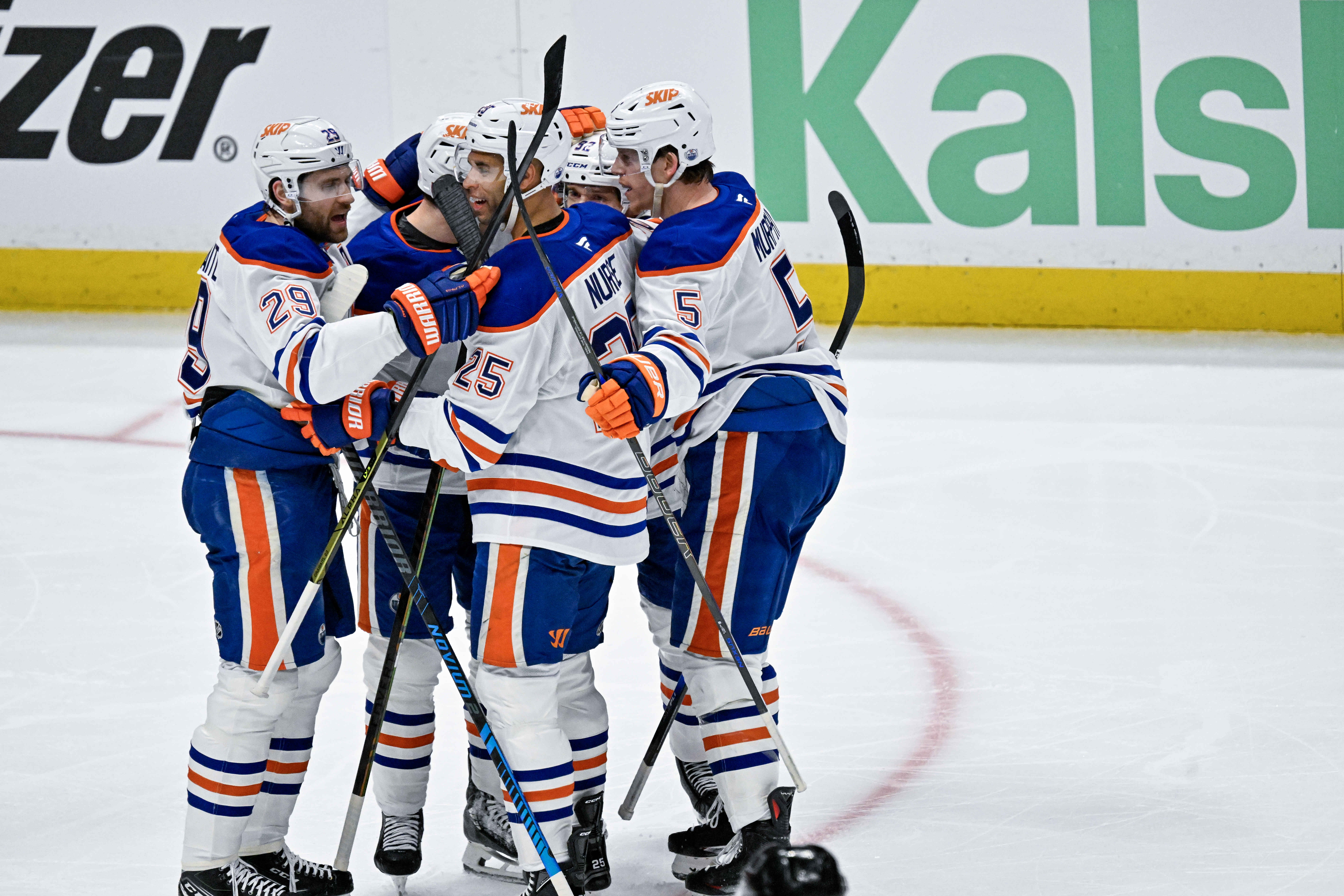 Oilers players celebrate a first period goal by Vasily Podkolzin...