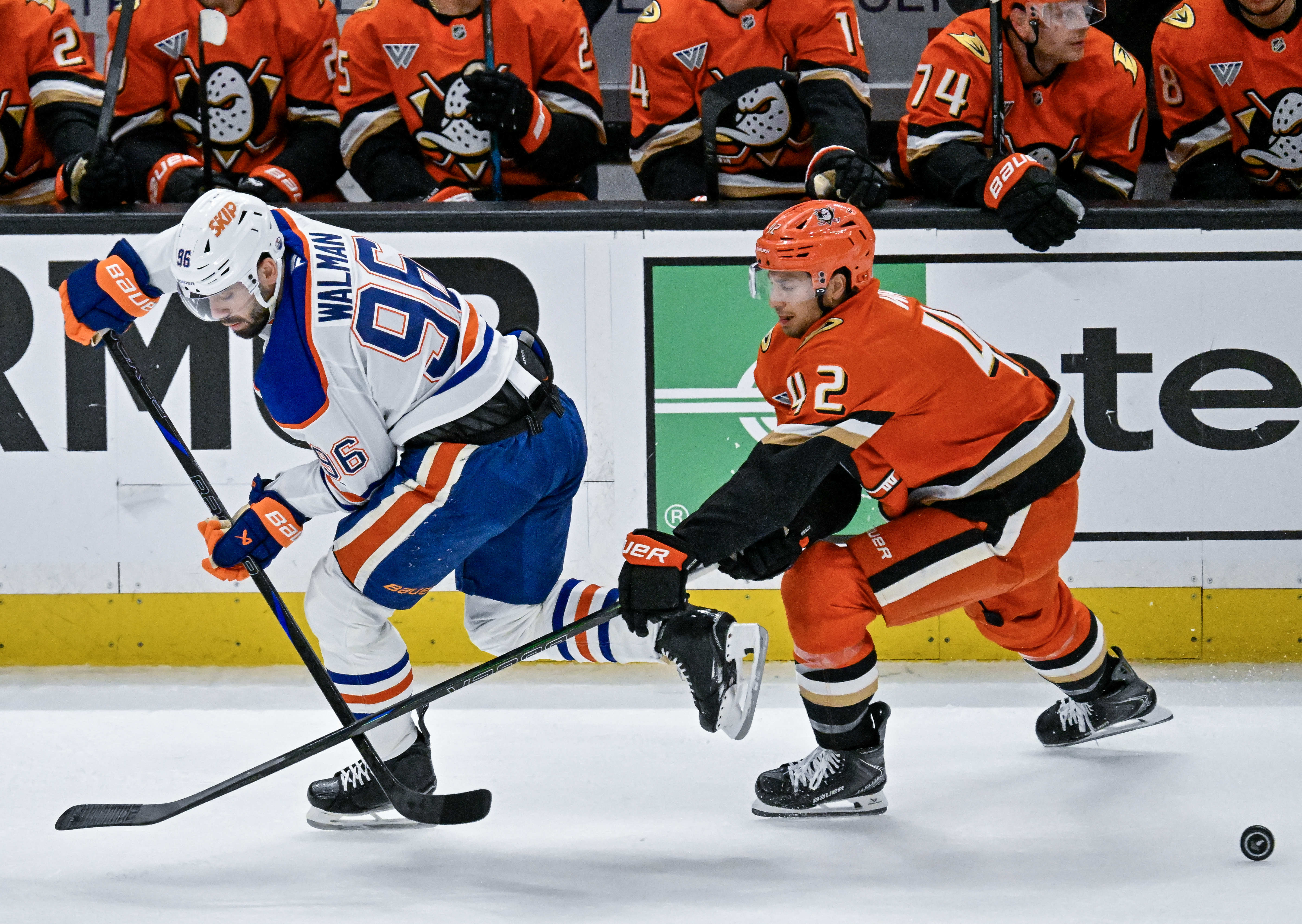 The Oilersâ Jake Walman (96), left, and the Ducksâ Tim...